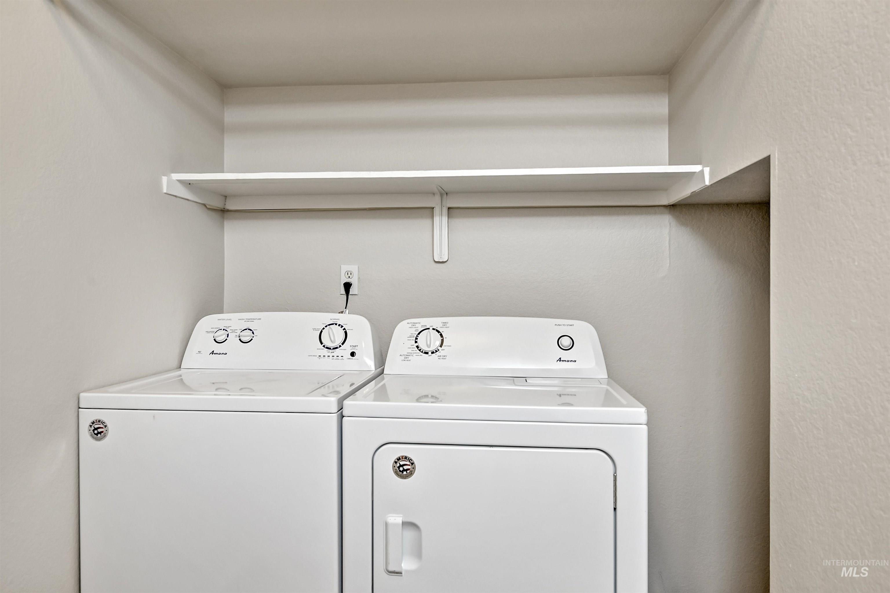 Unit B: Laundry room featuring washer and clothes dryer