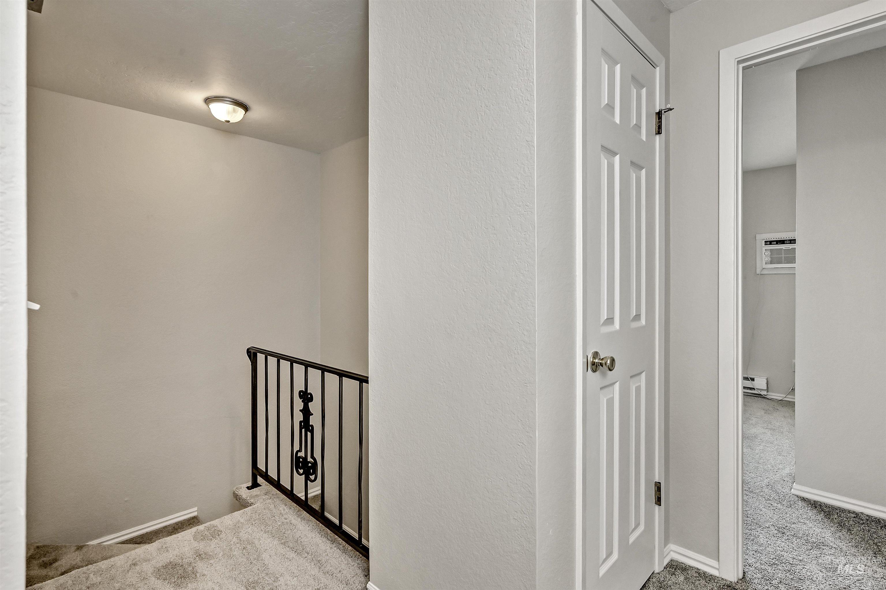 Unit B: Upstairs hall with carpet floors and a linen closet
