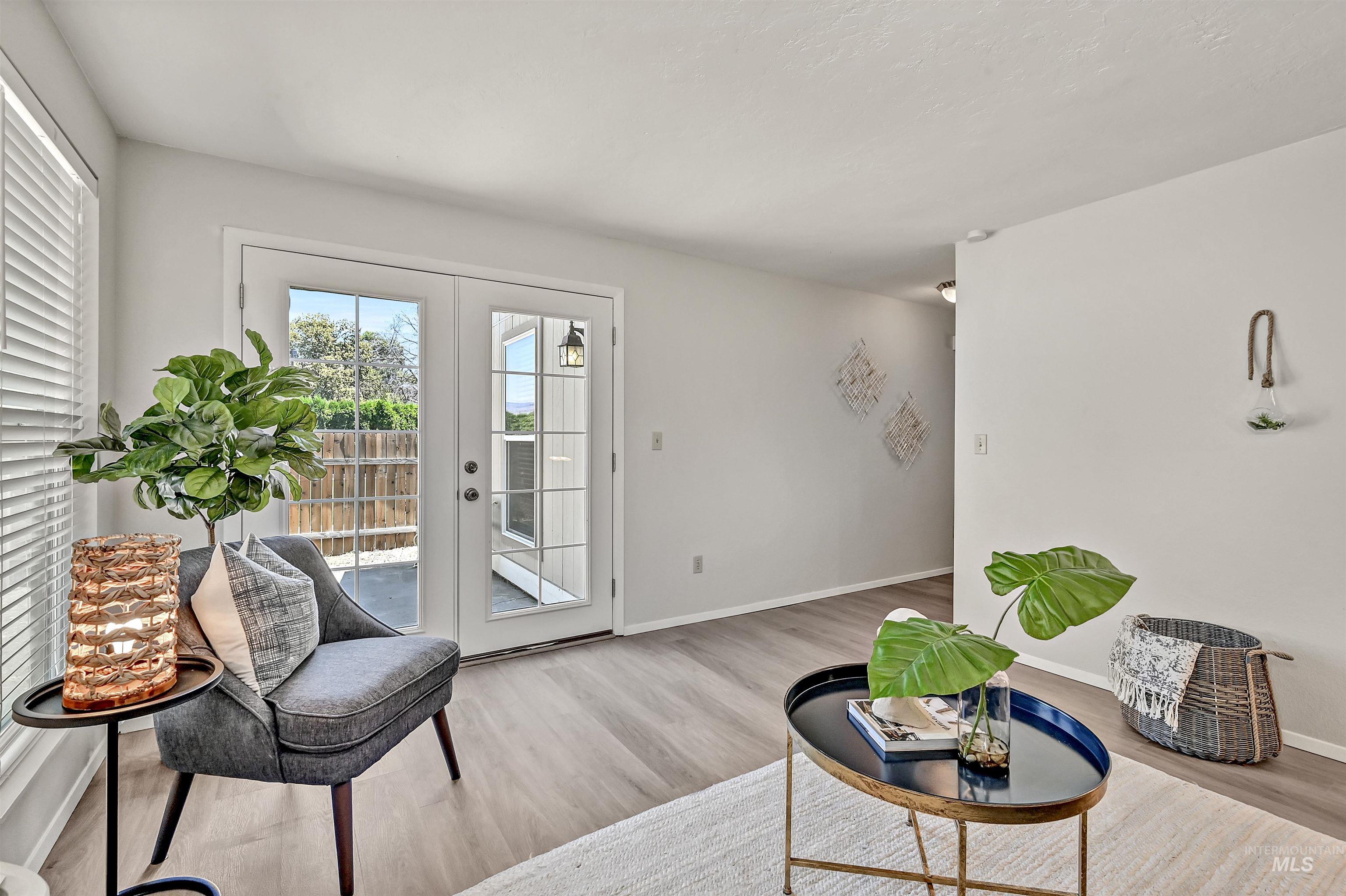 Unit A: Living area featuring french doors and LVP flooring