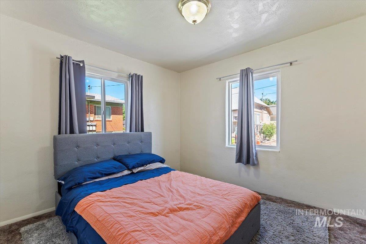 Carpeted bedroom with baseboards