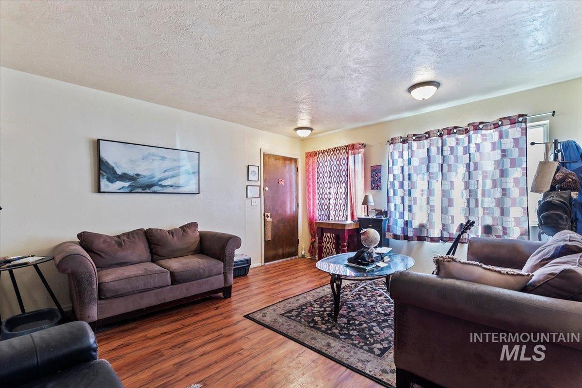 Living area featuring a textured ceiling and wood finished floors