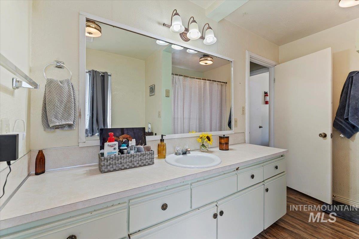 Bathroom featuring vanity and wood finished floors