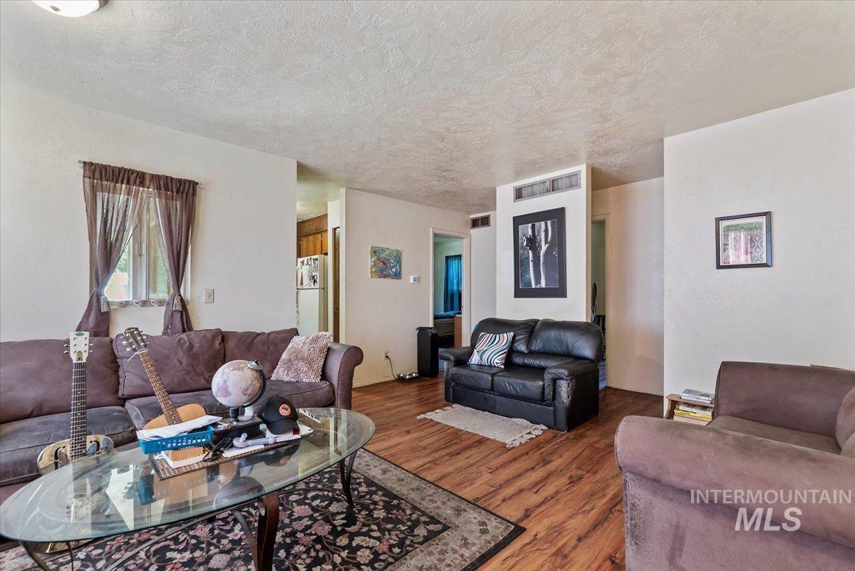 Living area with wood finished floors and a textured ceiling