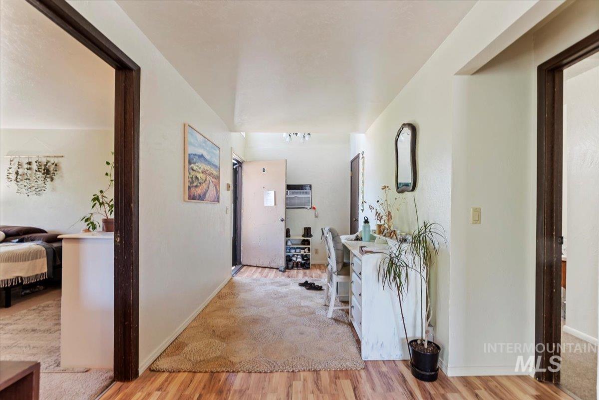 Corridor featuring light wood-type flooring and baseboards
