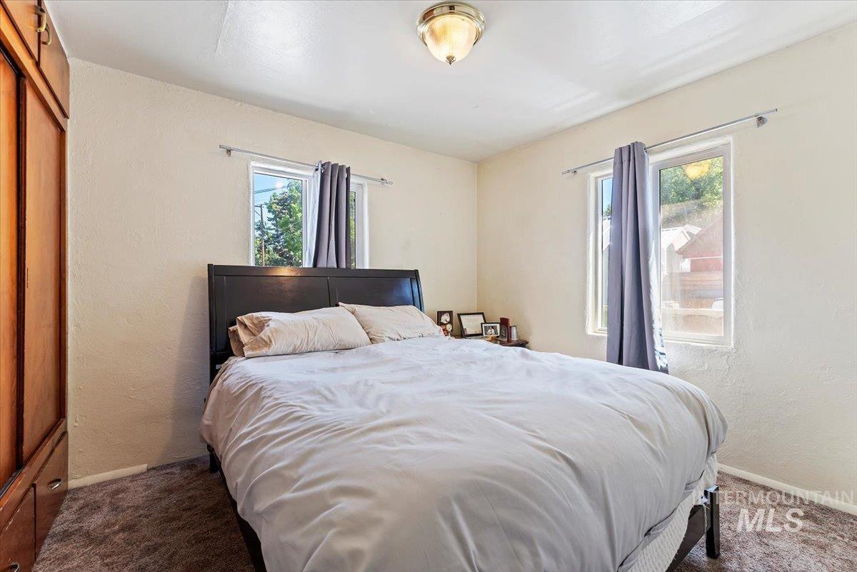 Bedroom with a textured wall and carpet