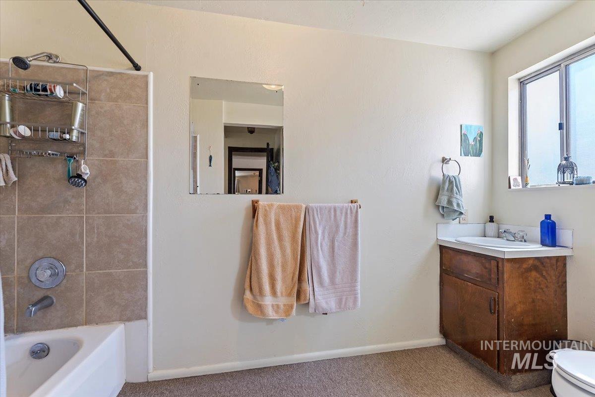 Bathroom with vanity and shower / washtub combination