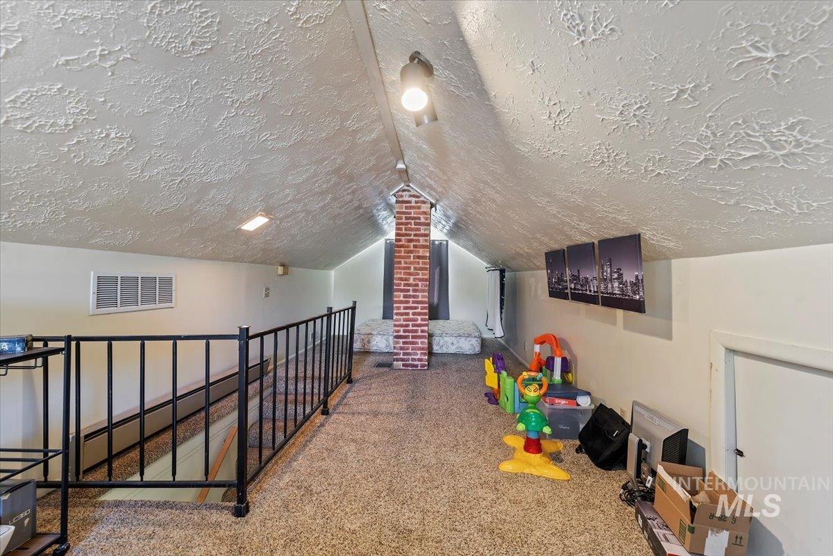 Rec room with vaulted ceiling