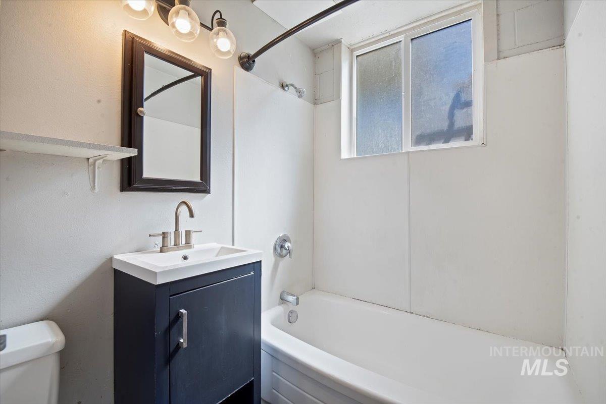 Bathroom featuring vanity and  shower combination