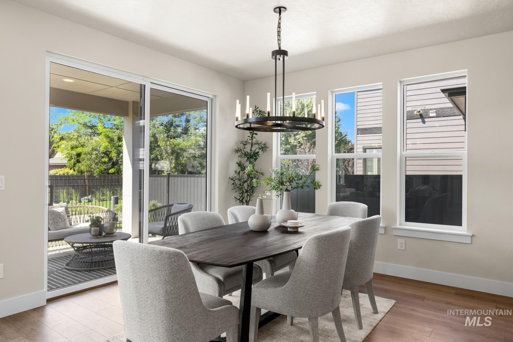 Dining room featuring light wood finished floors and a chandelier