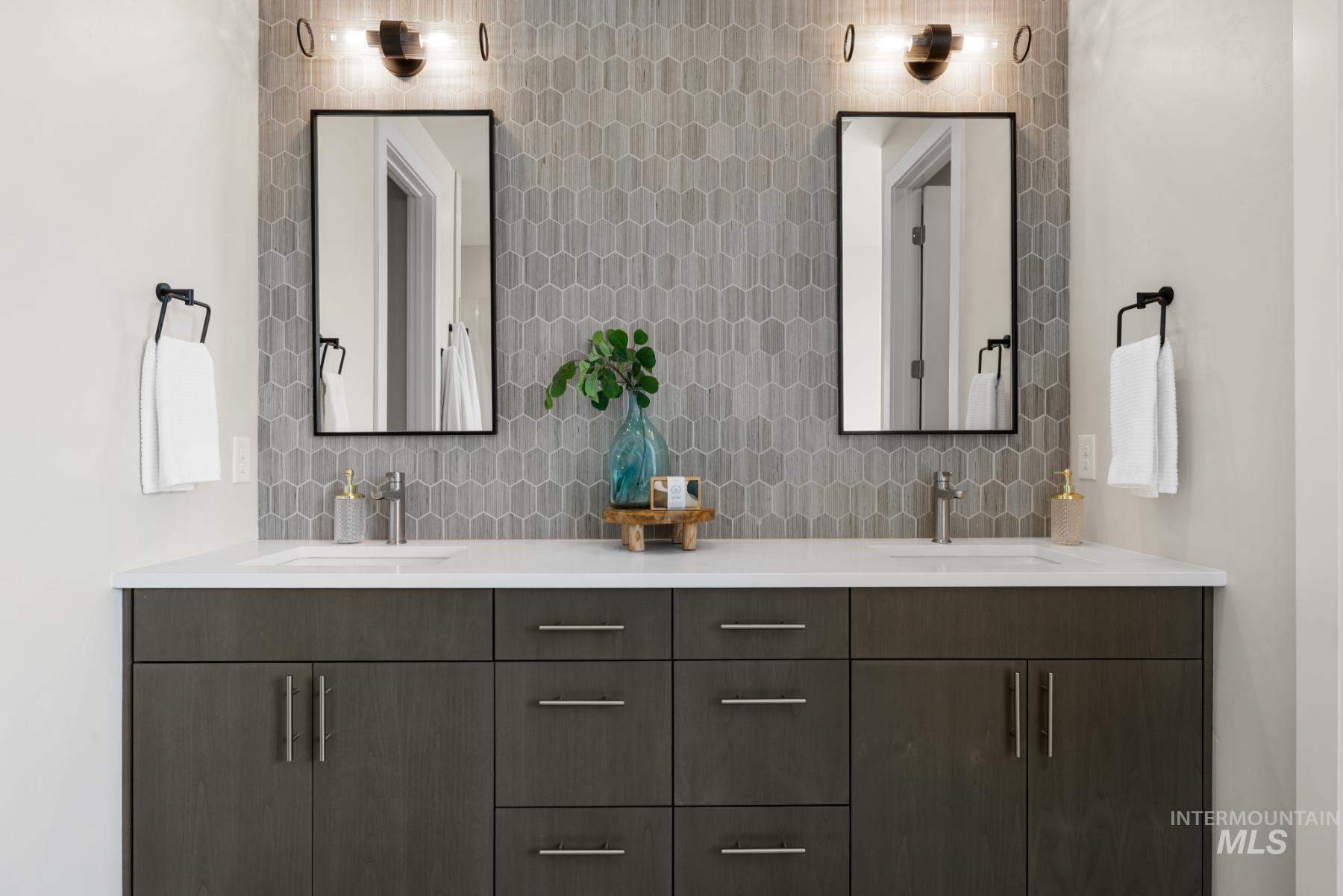 Bathroom featuring backsplash and double vanity