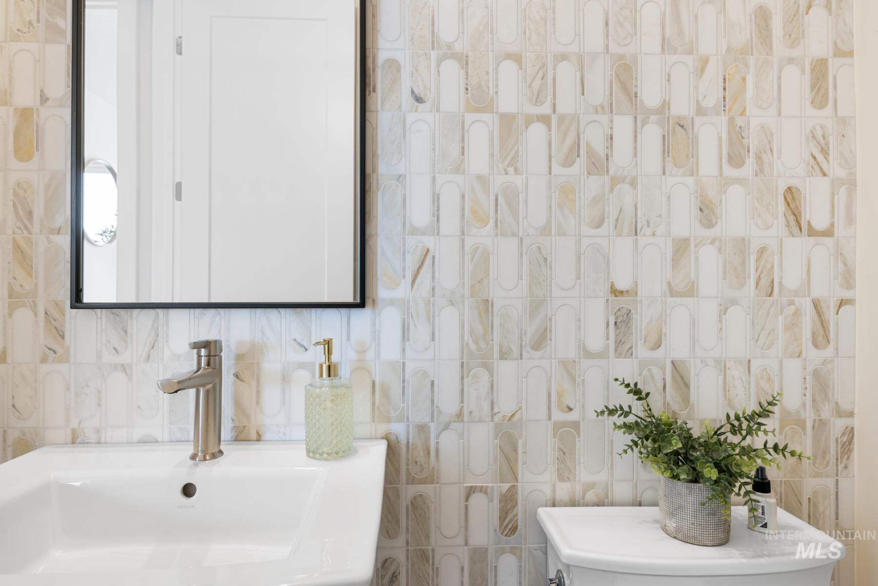 Bathroom featuring tile walls and backsplash