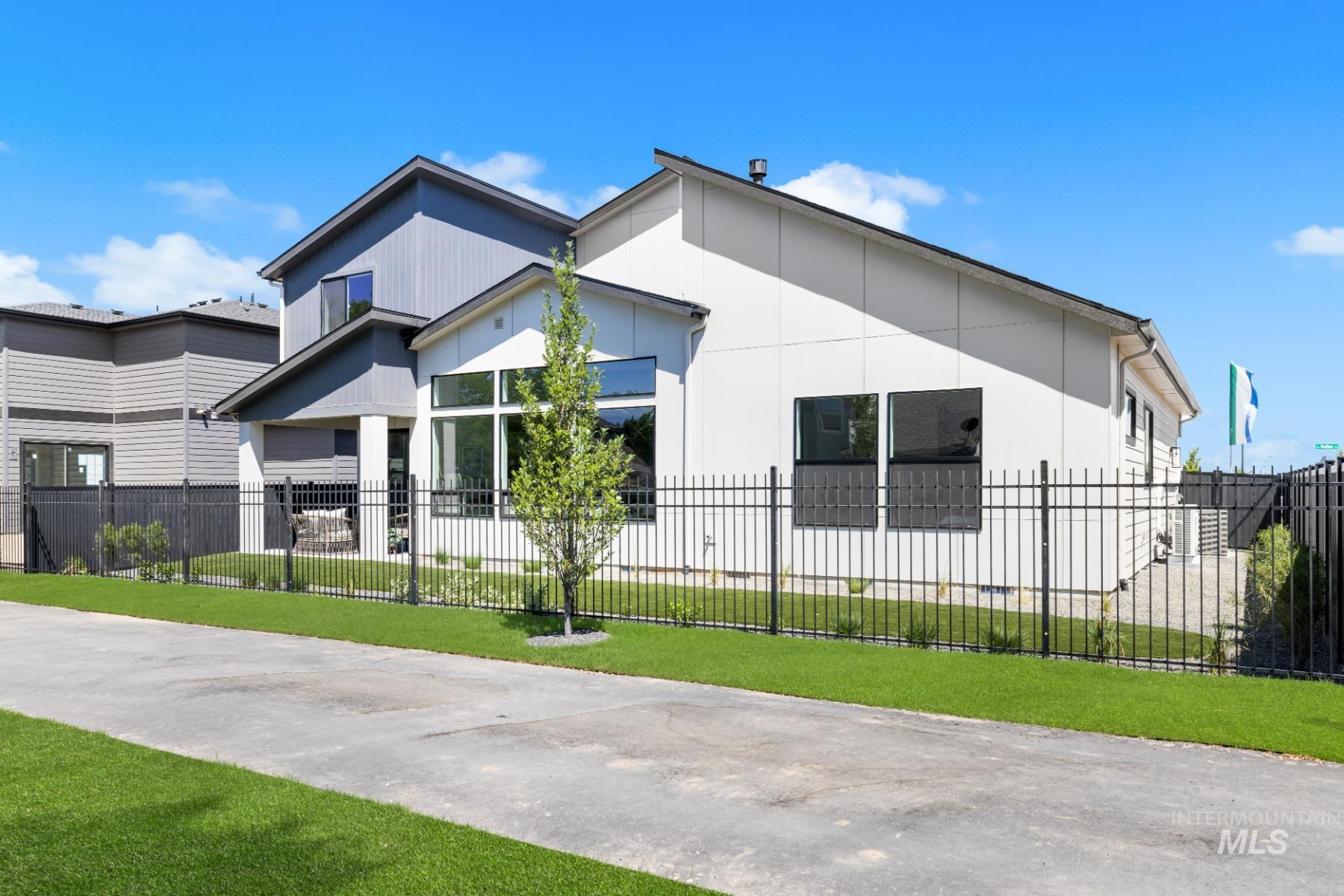 View of property exterior featuring a fenced front yard