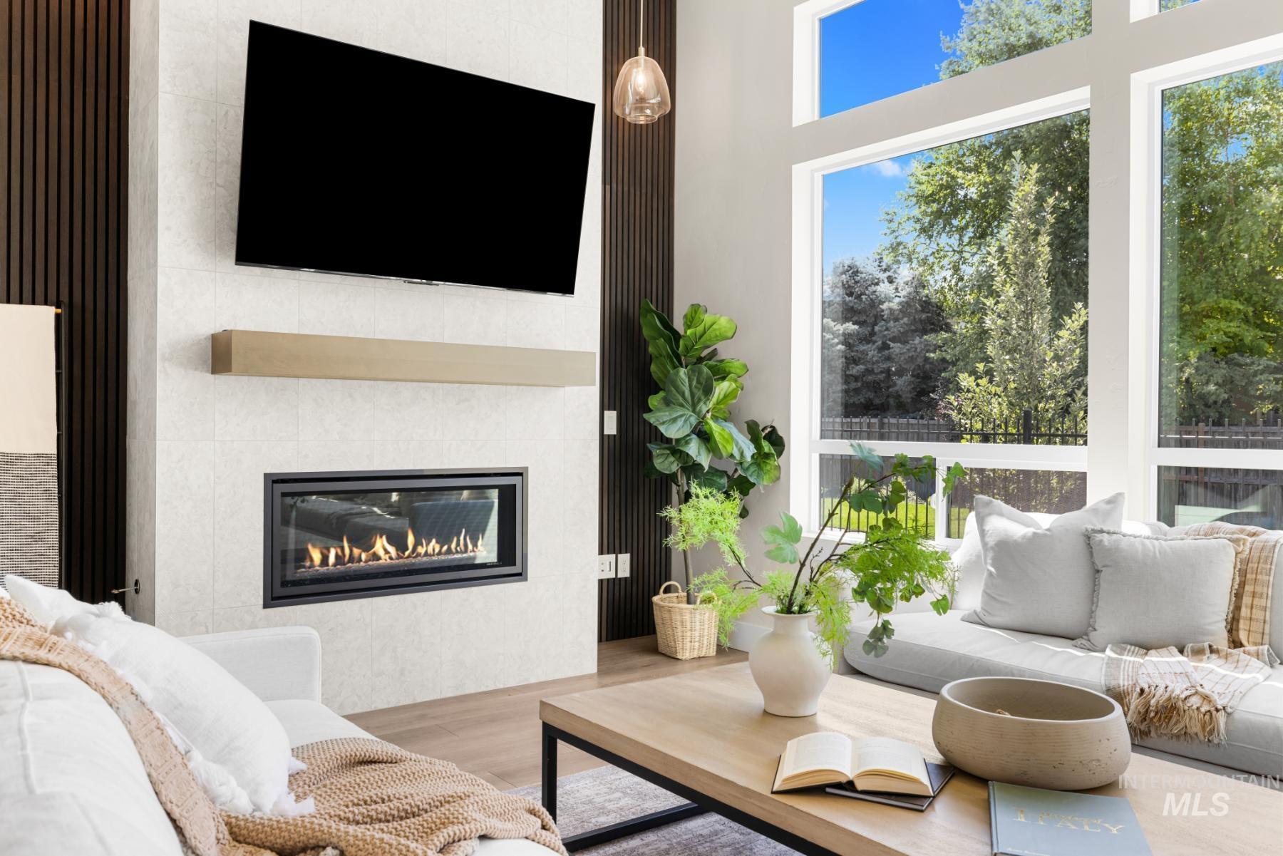 Living area featuring a glass covered fireplace and wood finished floors