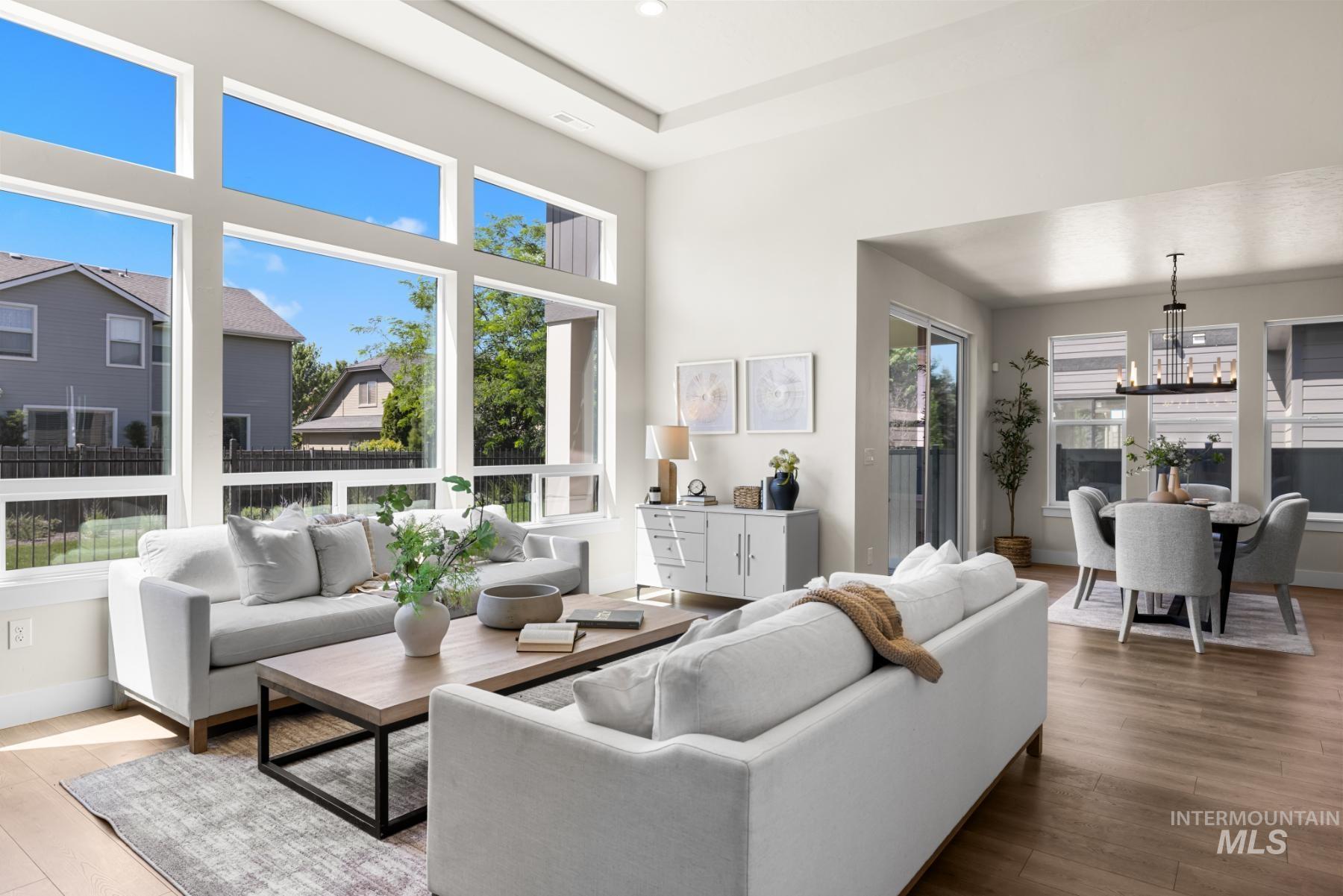 Living room with wood finished floors and a chandelier