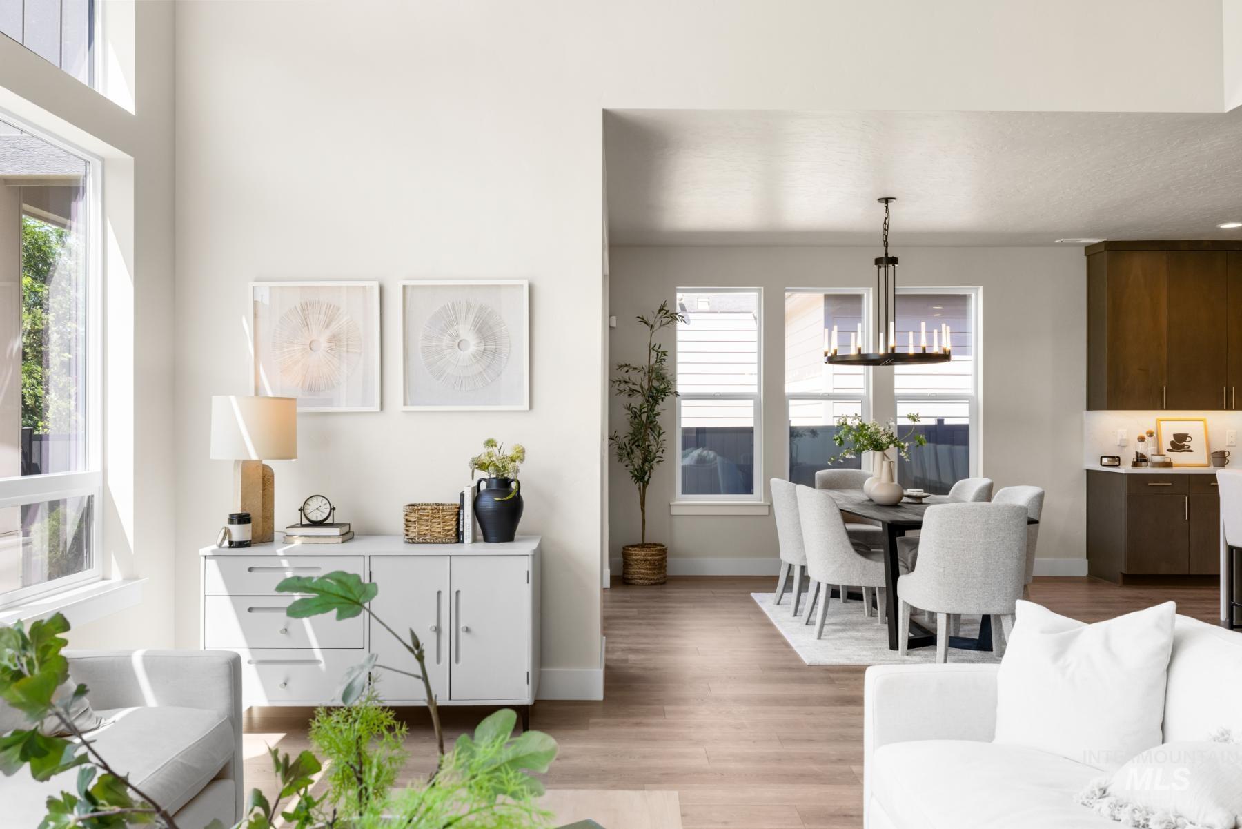 Living area with light wood-style floors and a chandelier