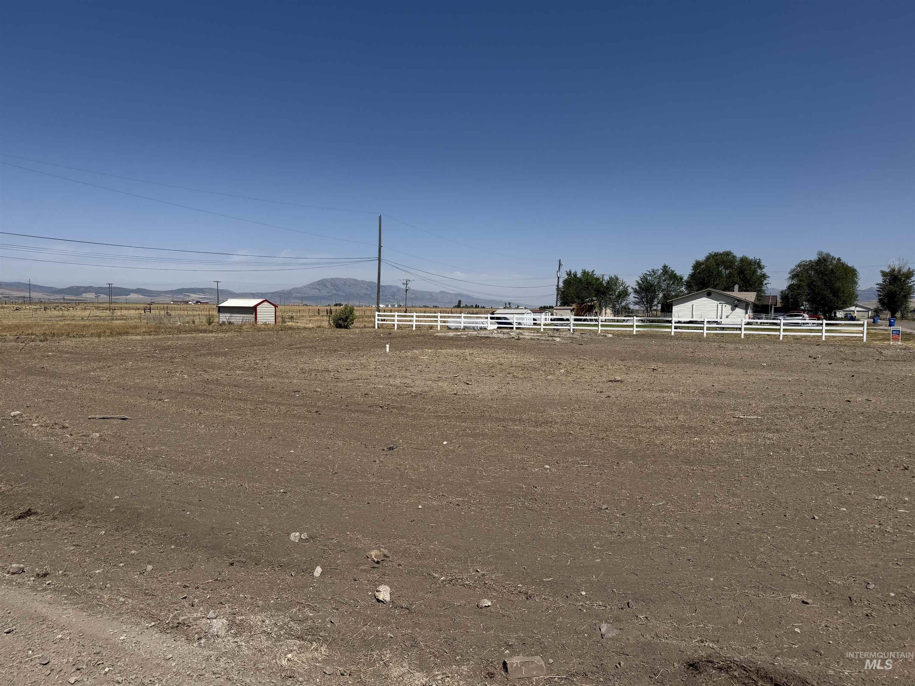 View of yard with a mountain view, a rural view, and an enclosed riding area