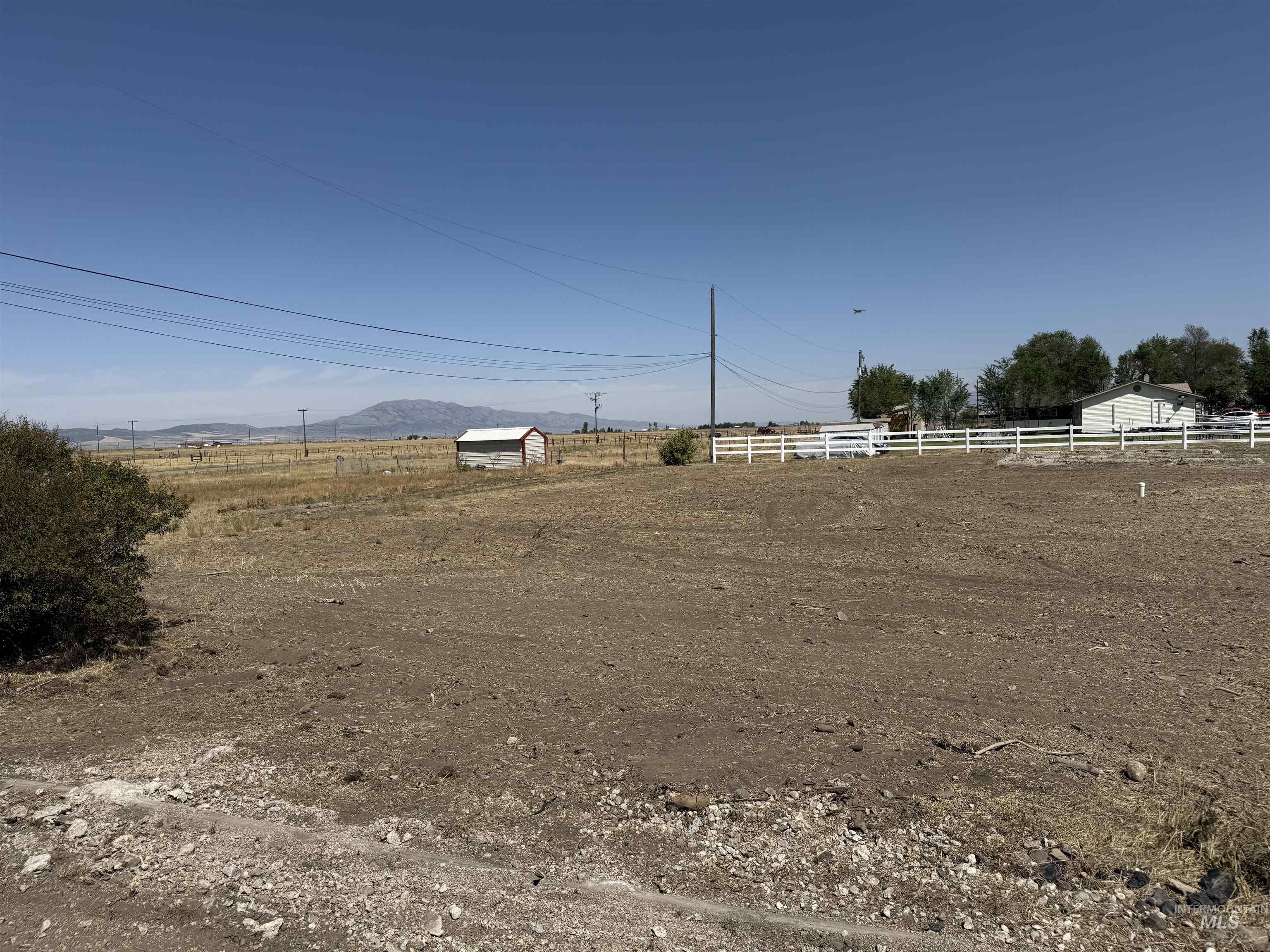 View of yard featuring a view of rural / pastoral area, a mountain view, and an outdoor structure