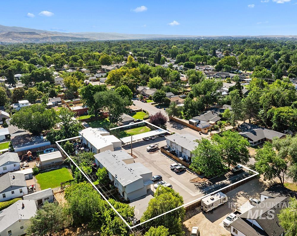 Aerial perspective of suburban area featuring property boundaries highlighted