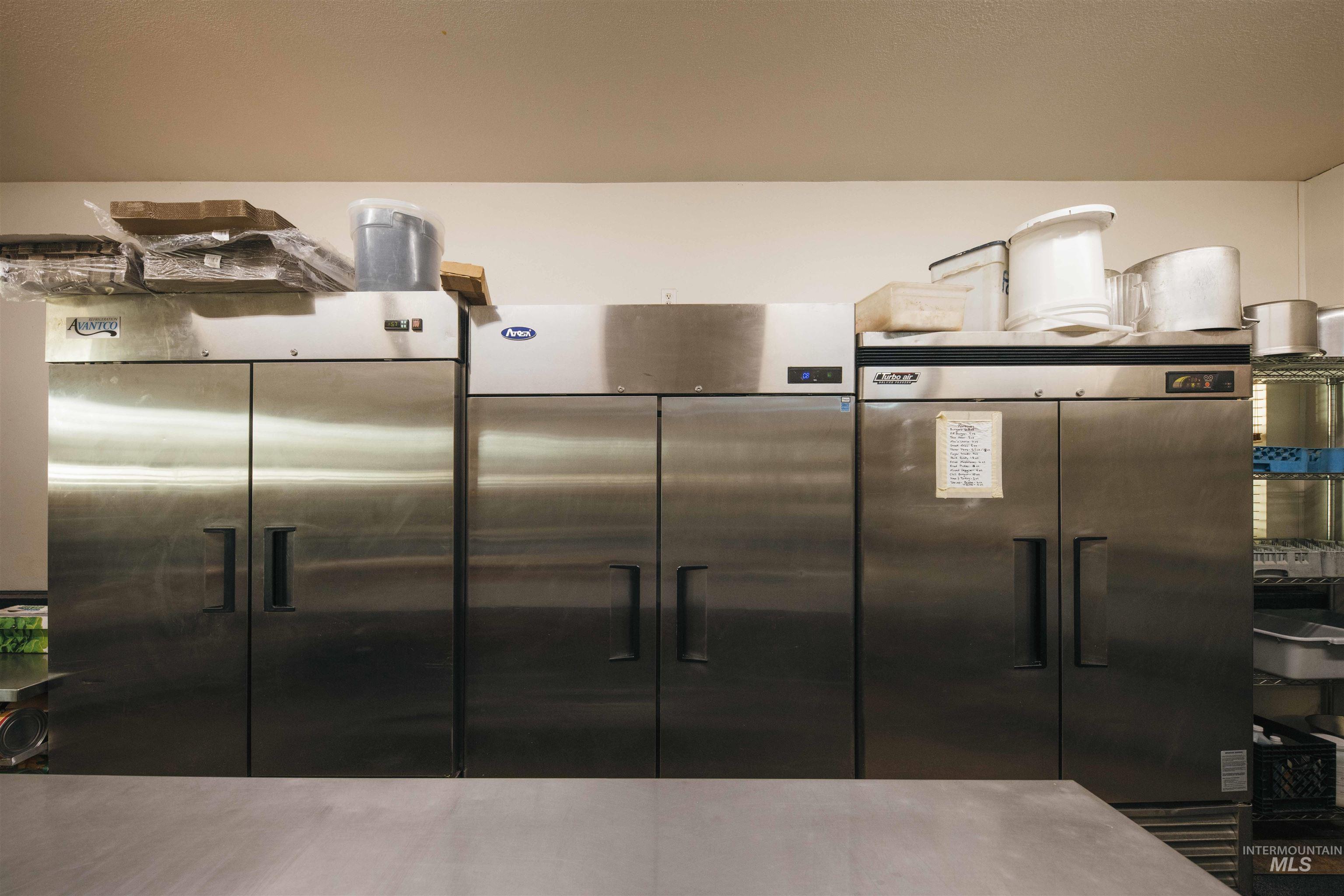 Kitchen with stainless steel built in fridge and high end refrigerator
