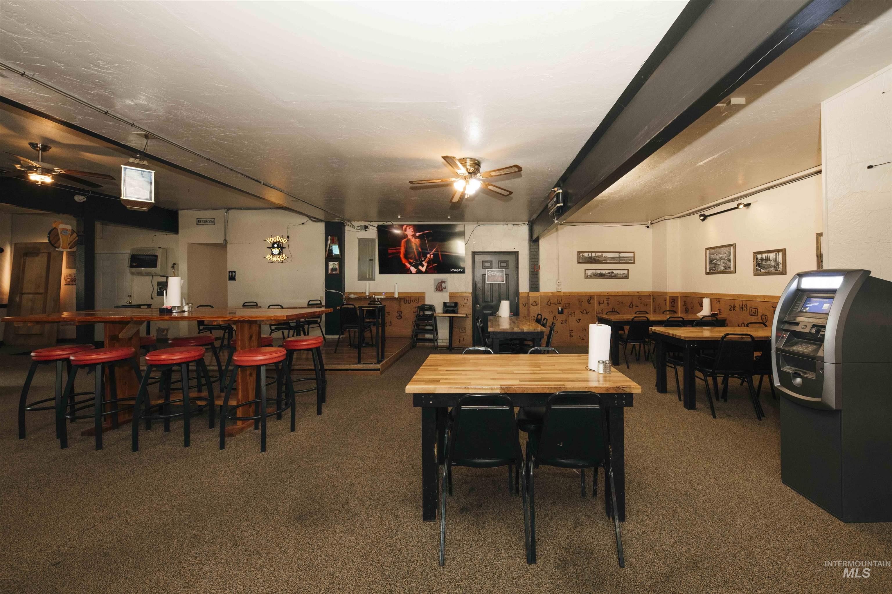 Dining area with a ceiling fan and carpet flooring