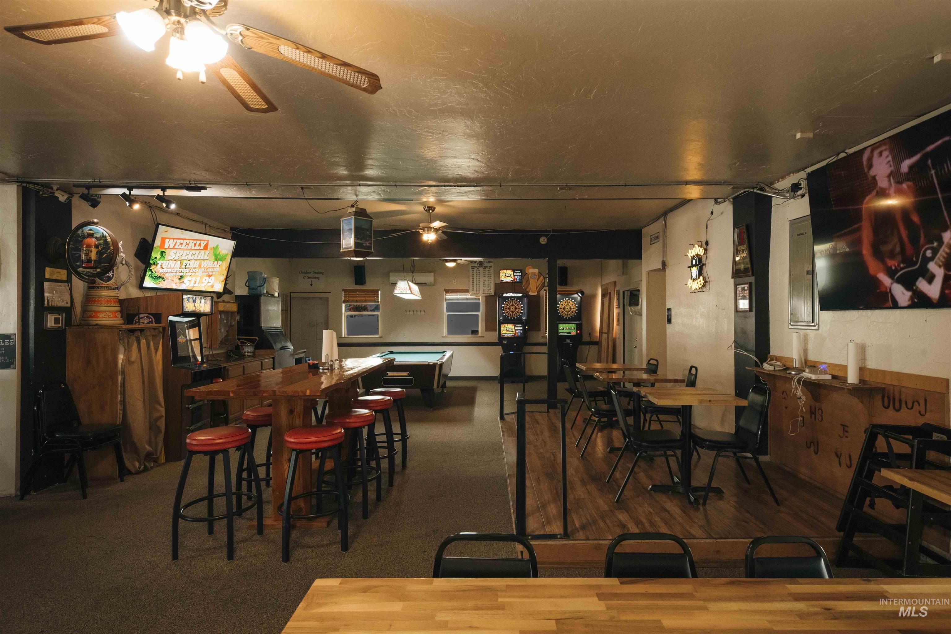 Dining space featuring a ceiling fan and wood finished floors