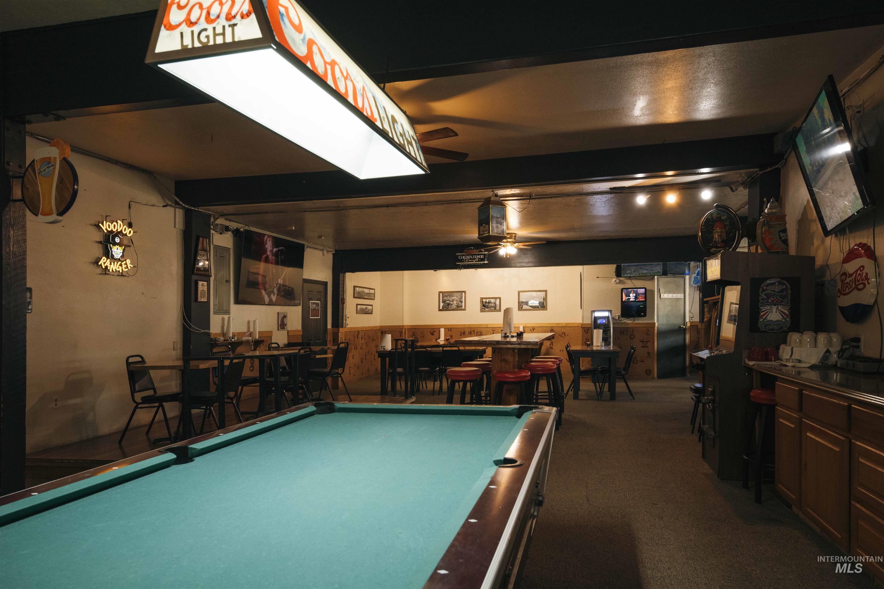 Recreation room with billiards, carpet, wooden walls, a wainscoted wall, and ceiling fan