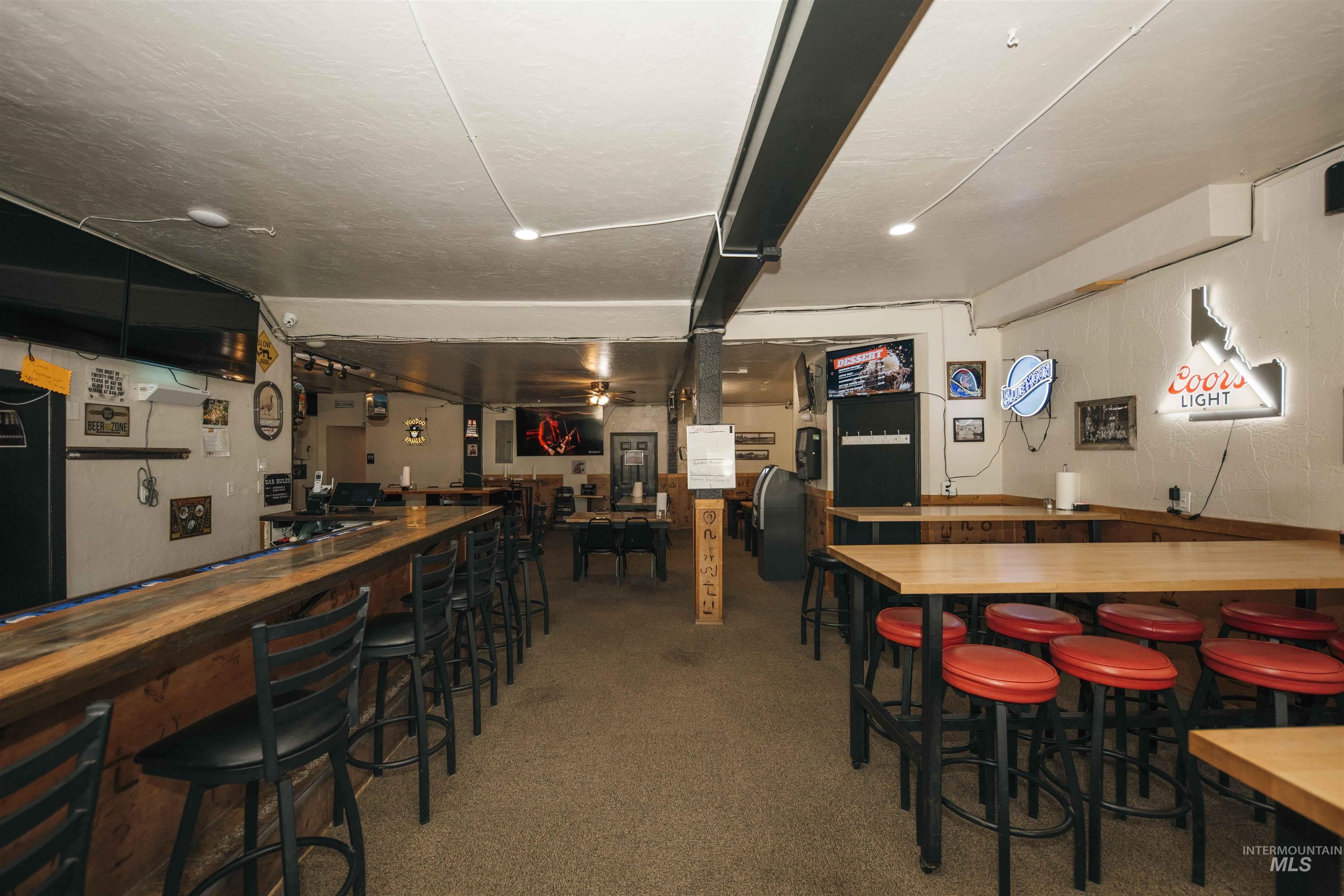 Indoor dry bar with a textured ceiling and a textured wall