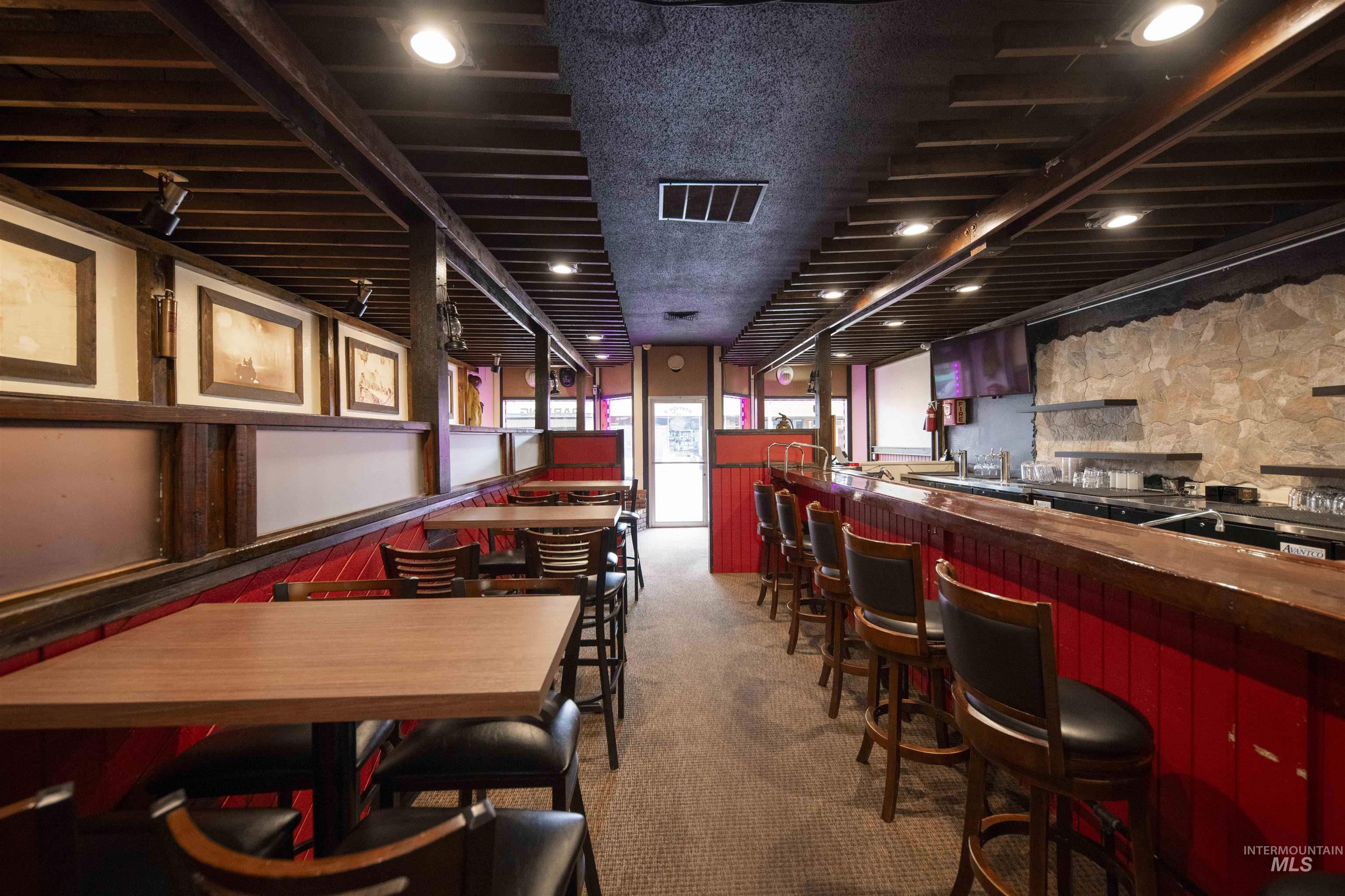 Carpeted dining space with a community bar