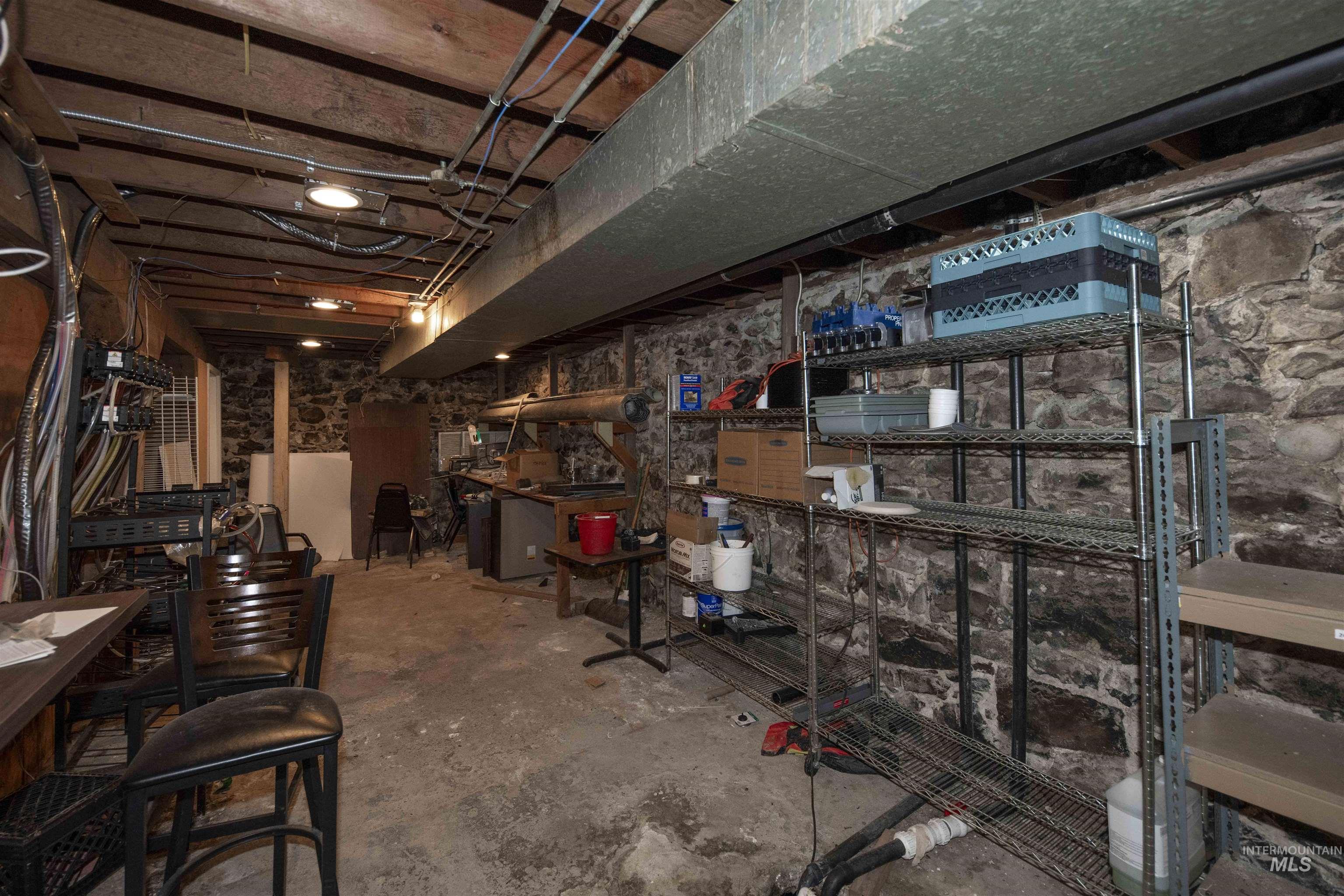 Unfinished below grade area featuring a heating unit