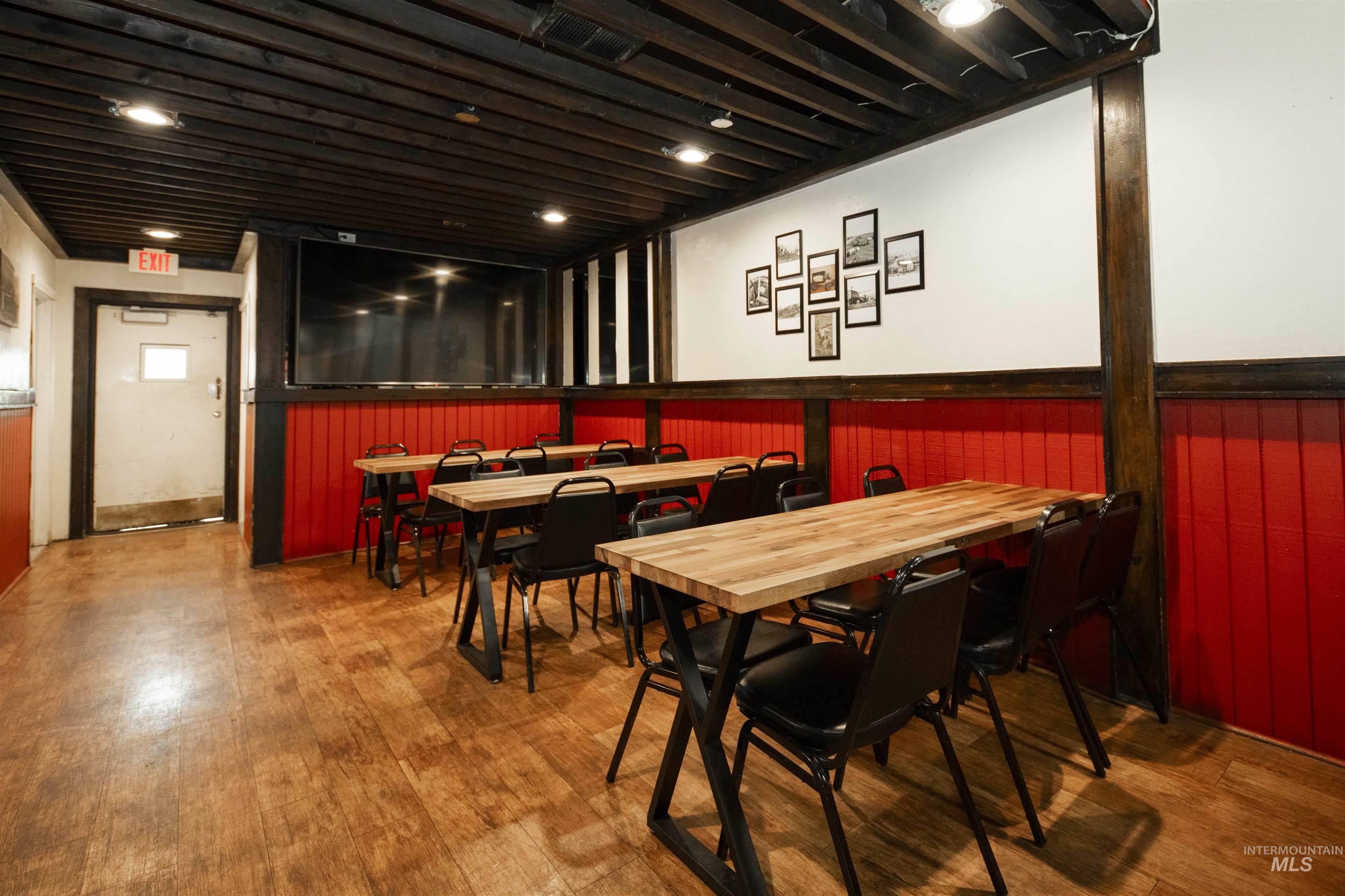 Dining area with wainscoting and wood finished floors