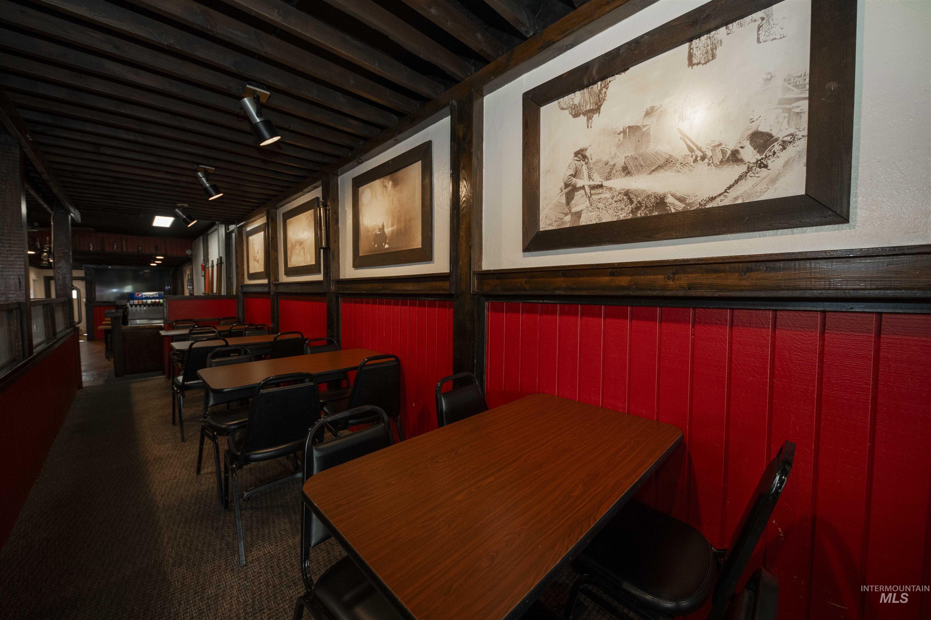 Dining area featuring carpet, wainscoting, and an office area