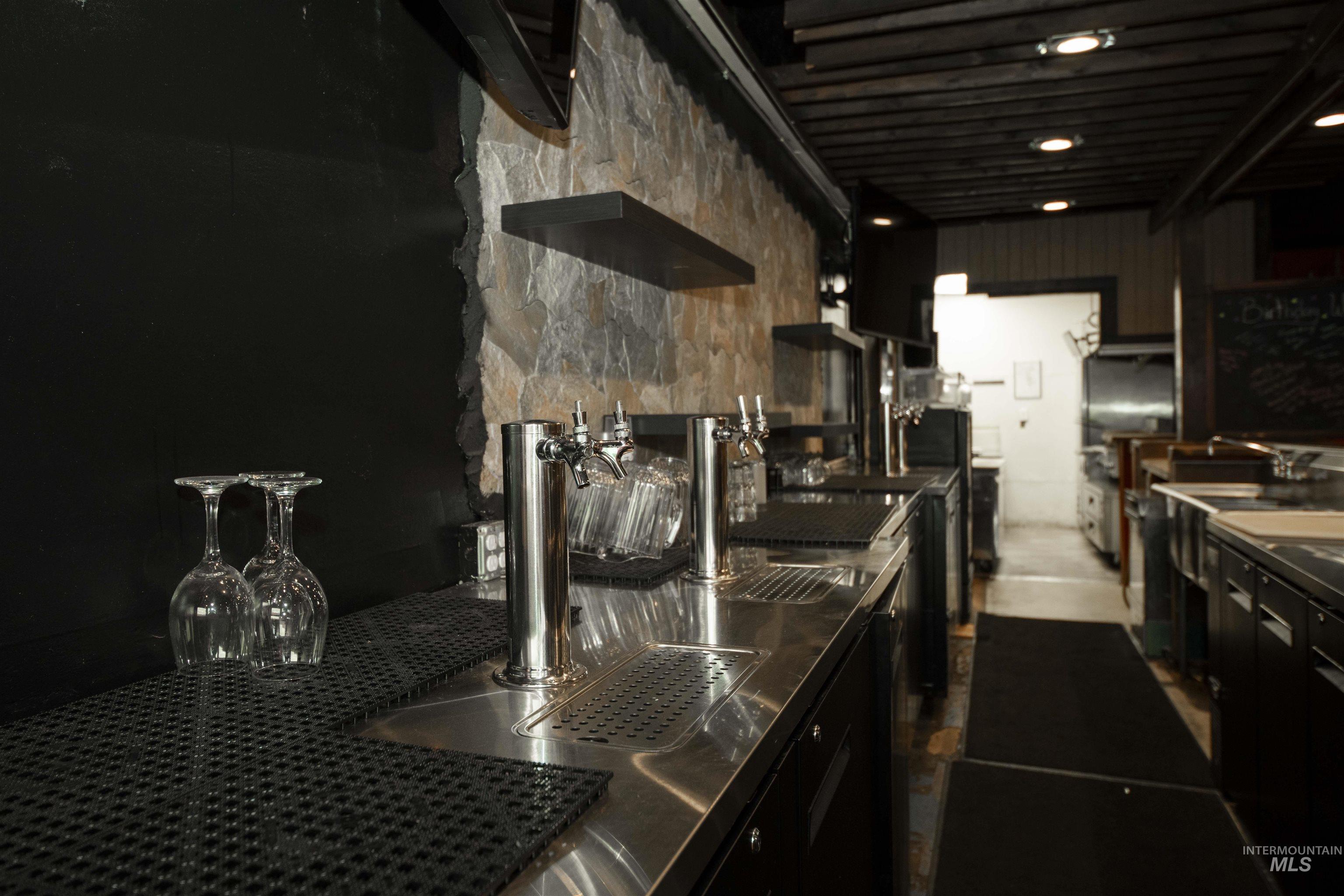 Behind bar with stainless steel counters and a sink
