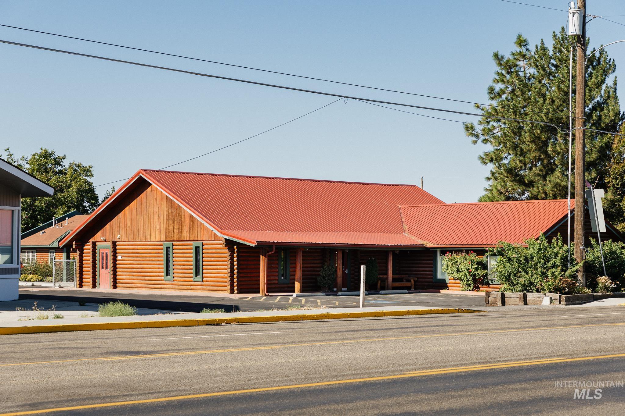 Log cabin with log exterior and a metal roof