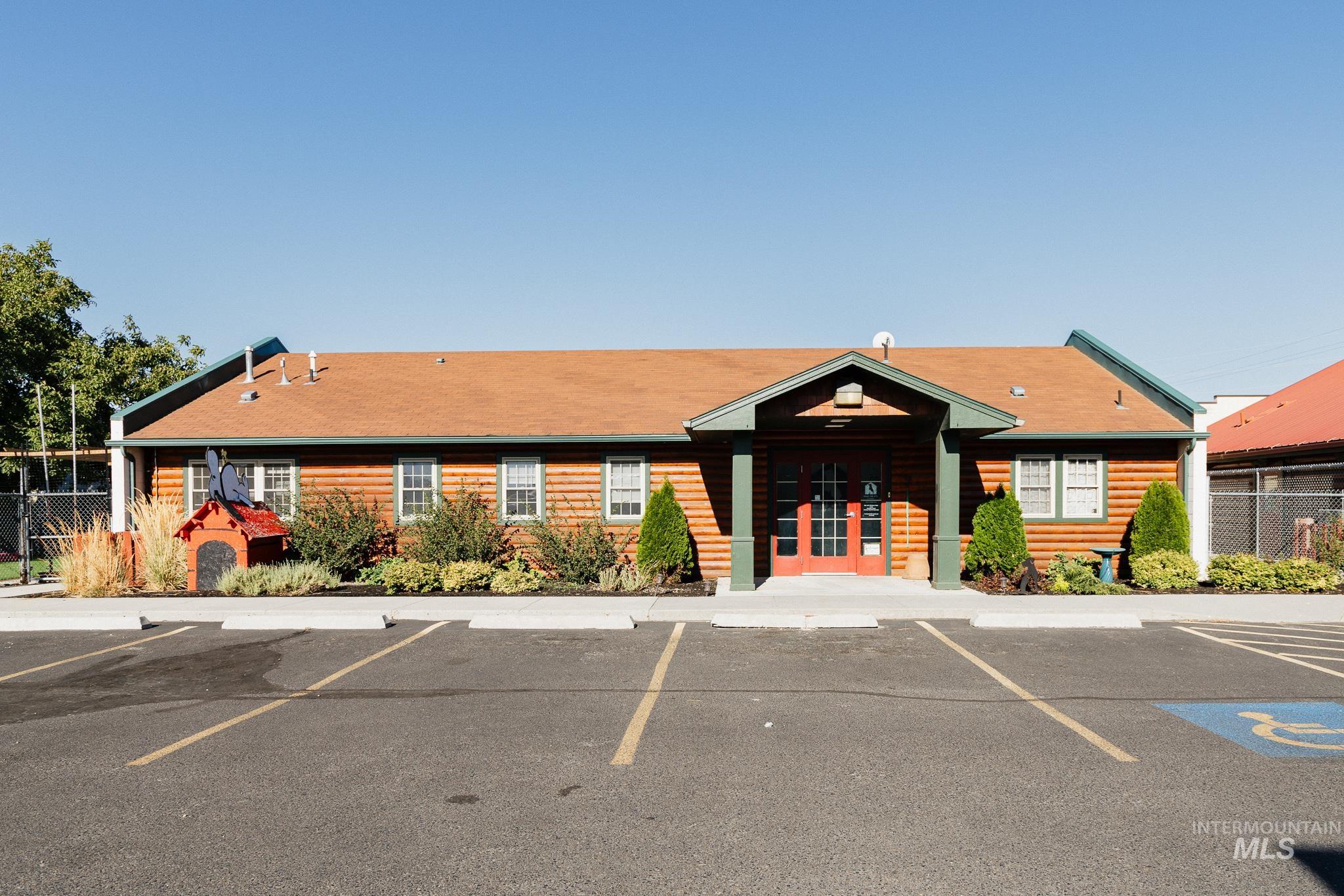 View of building exterior with uncovered parking