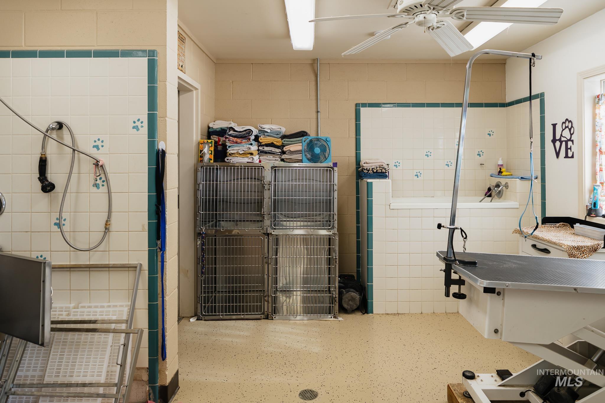 Bathroom featuring pet washing area and tile walls