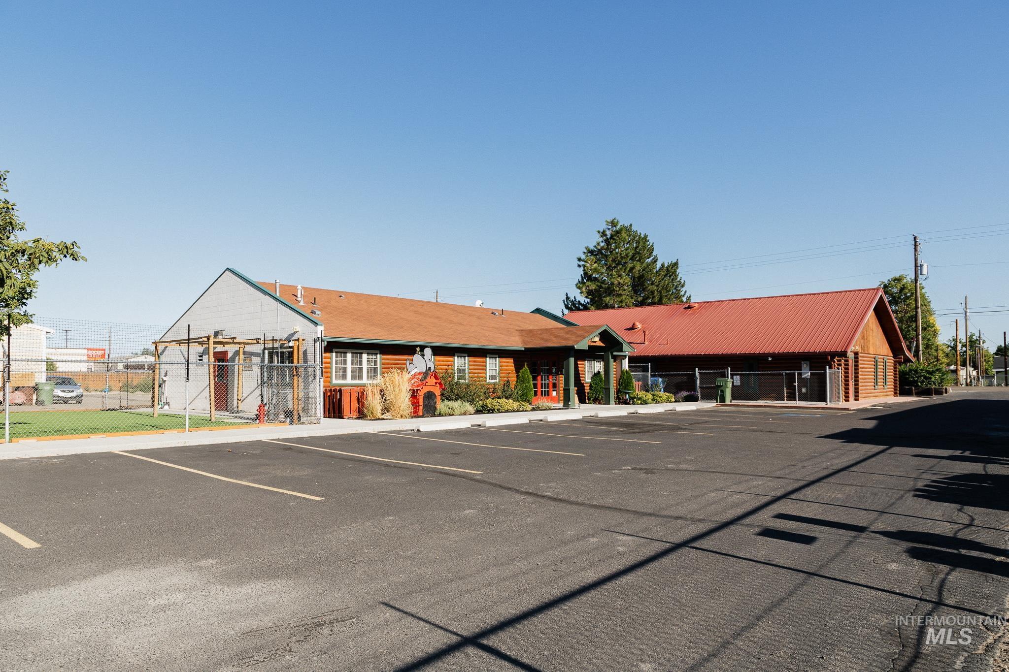 View of building exterior featuring uncovered parking