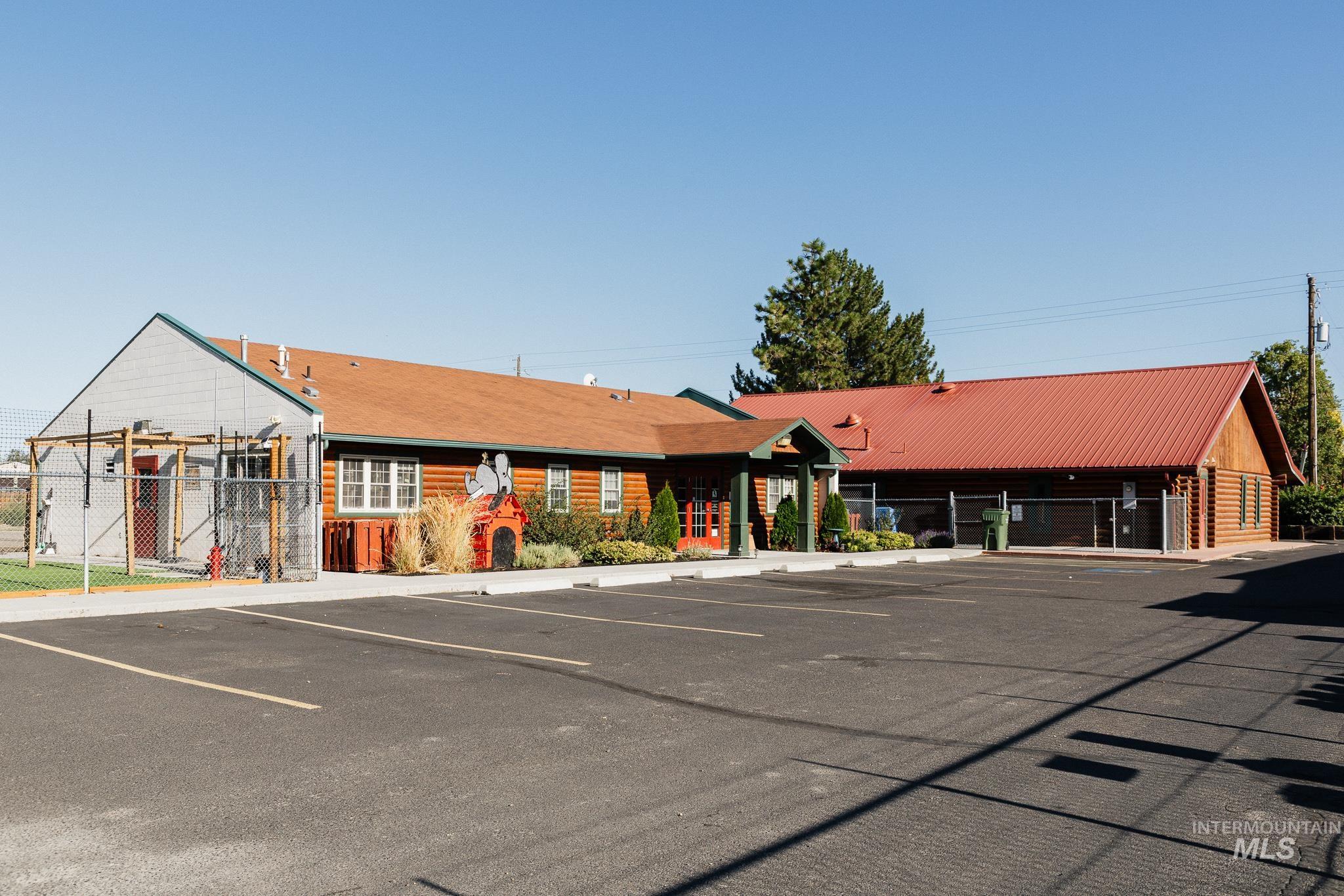 View of building exterior featuring uncovered parking