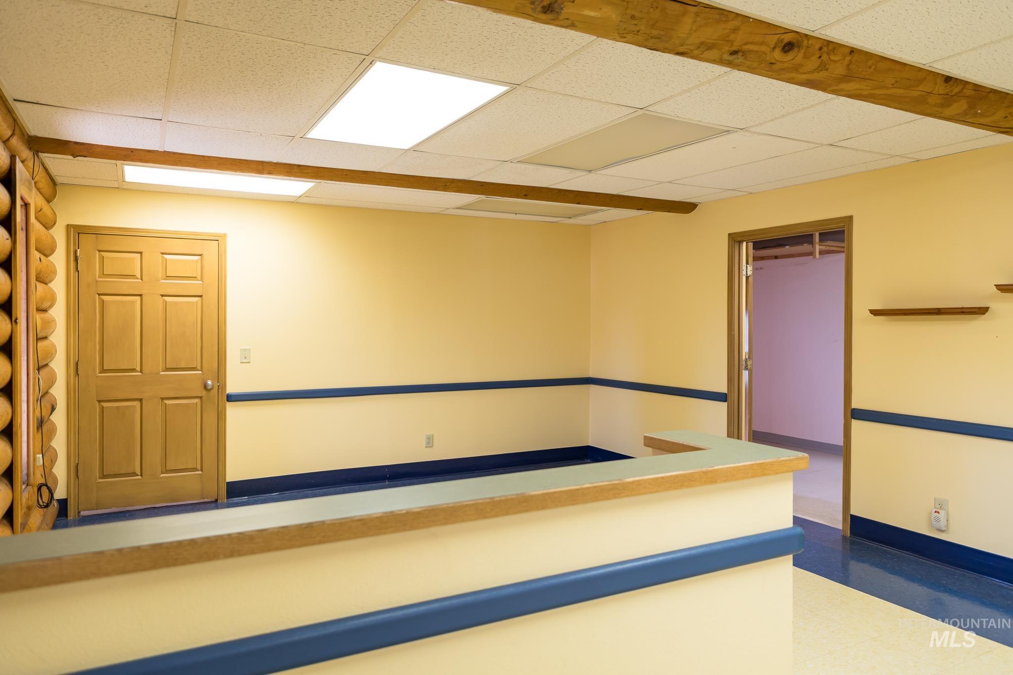 Spare room with a paneled ceiling and tile patterned floors