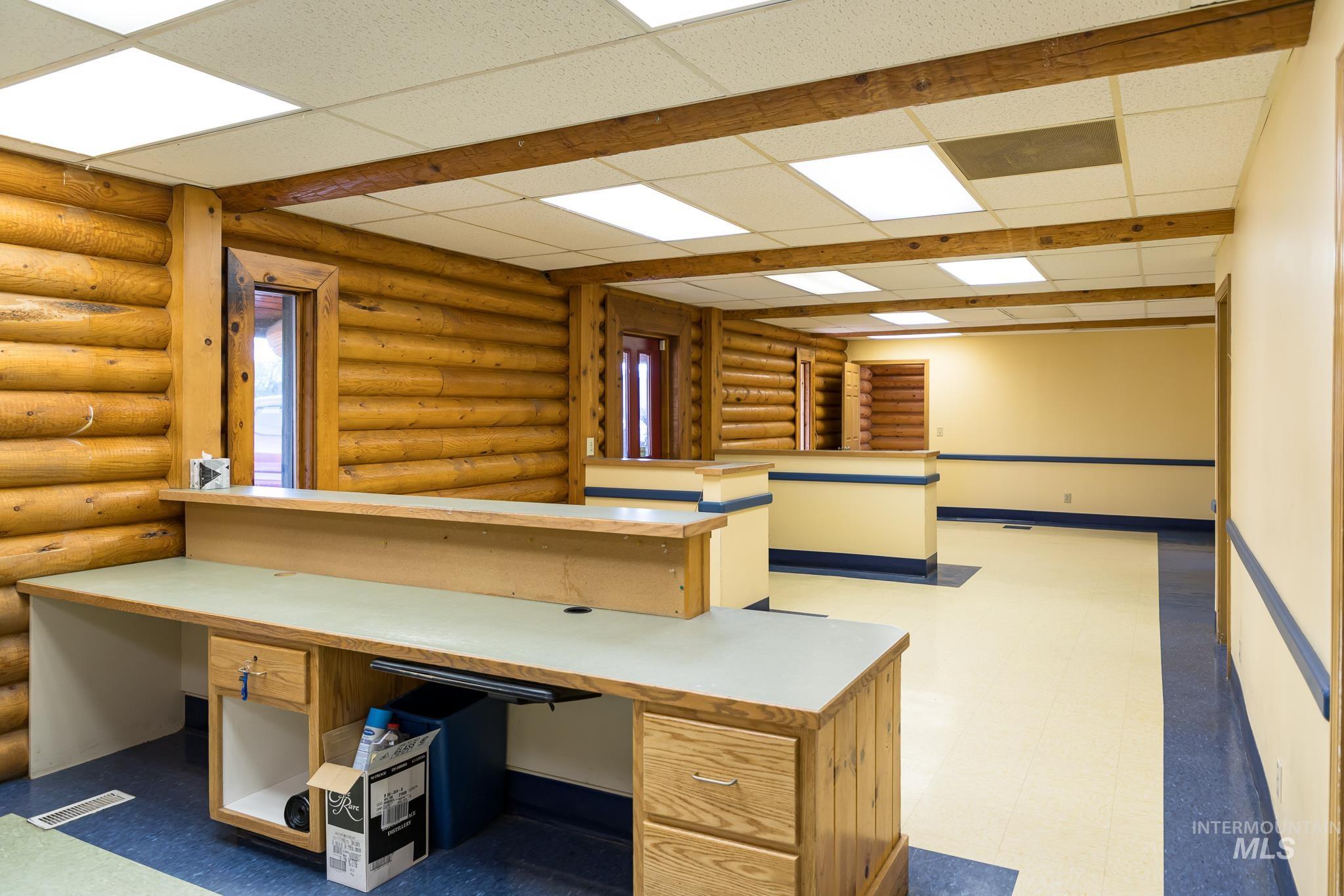 Unfurnished office featuring light flooring and a paneled ceiling