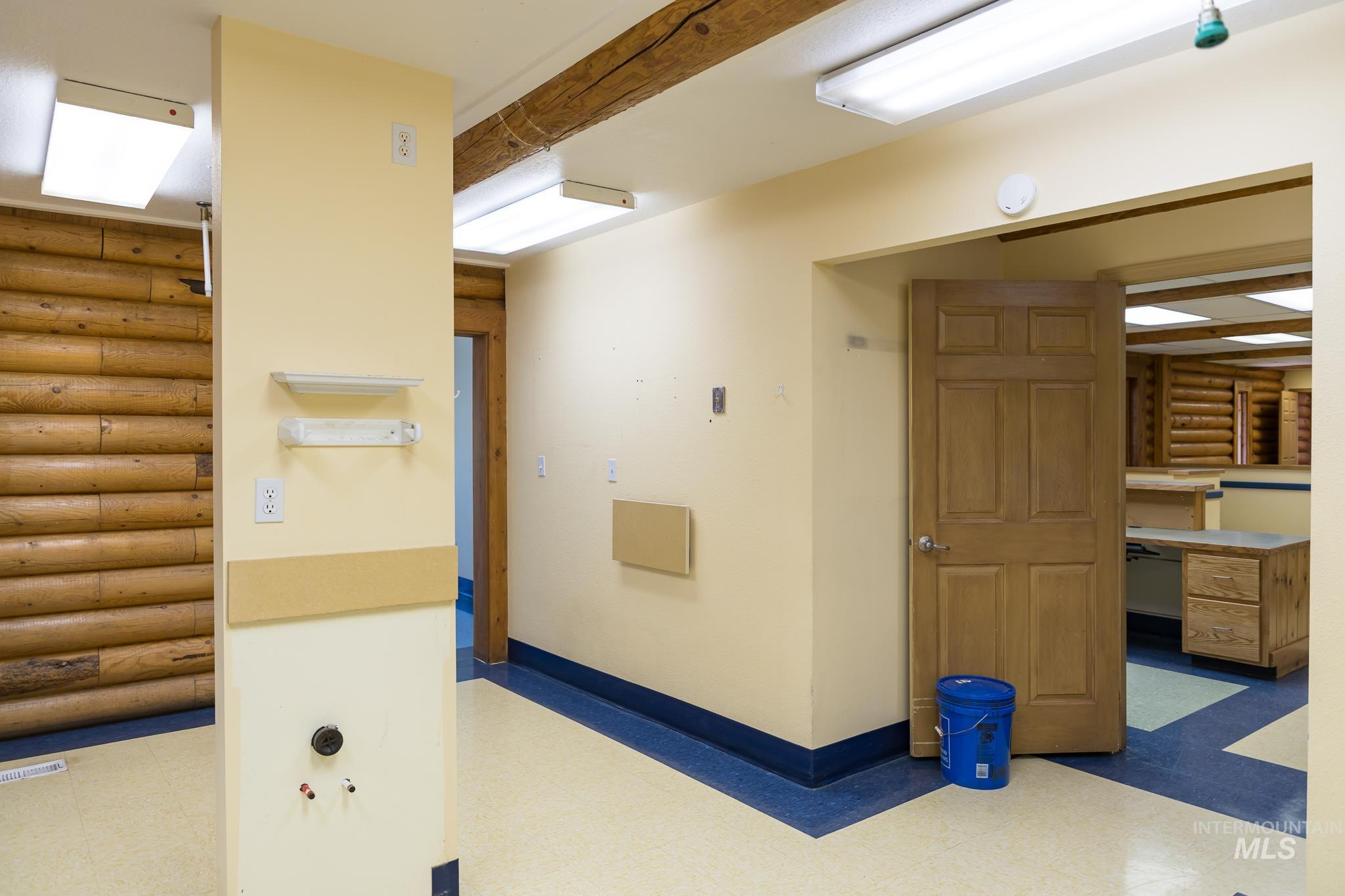 Corridor with tile patterned floors and an office area