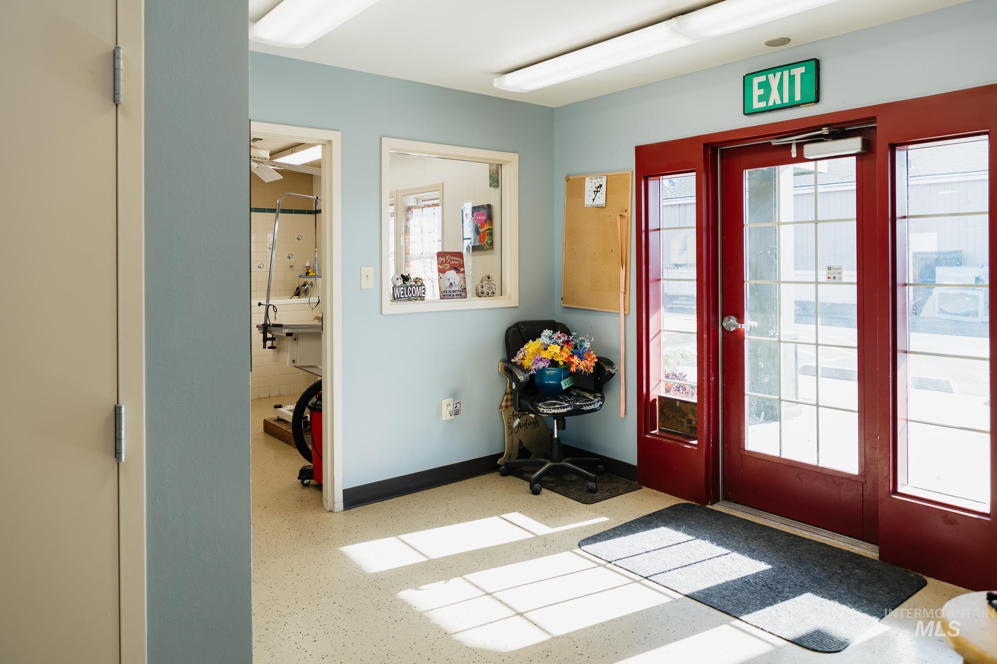 Entryway featuring plenty of natural light, ceiling fan, and speckled floor