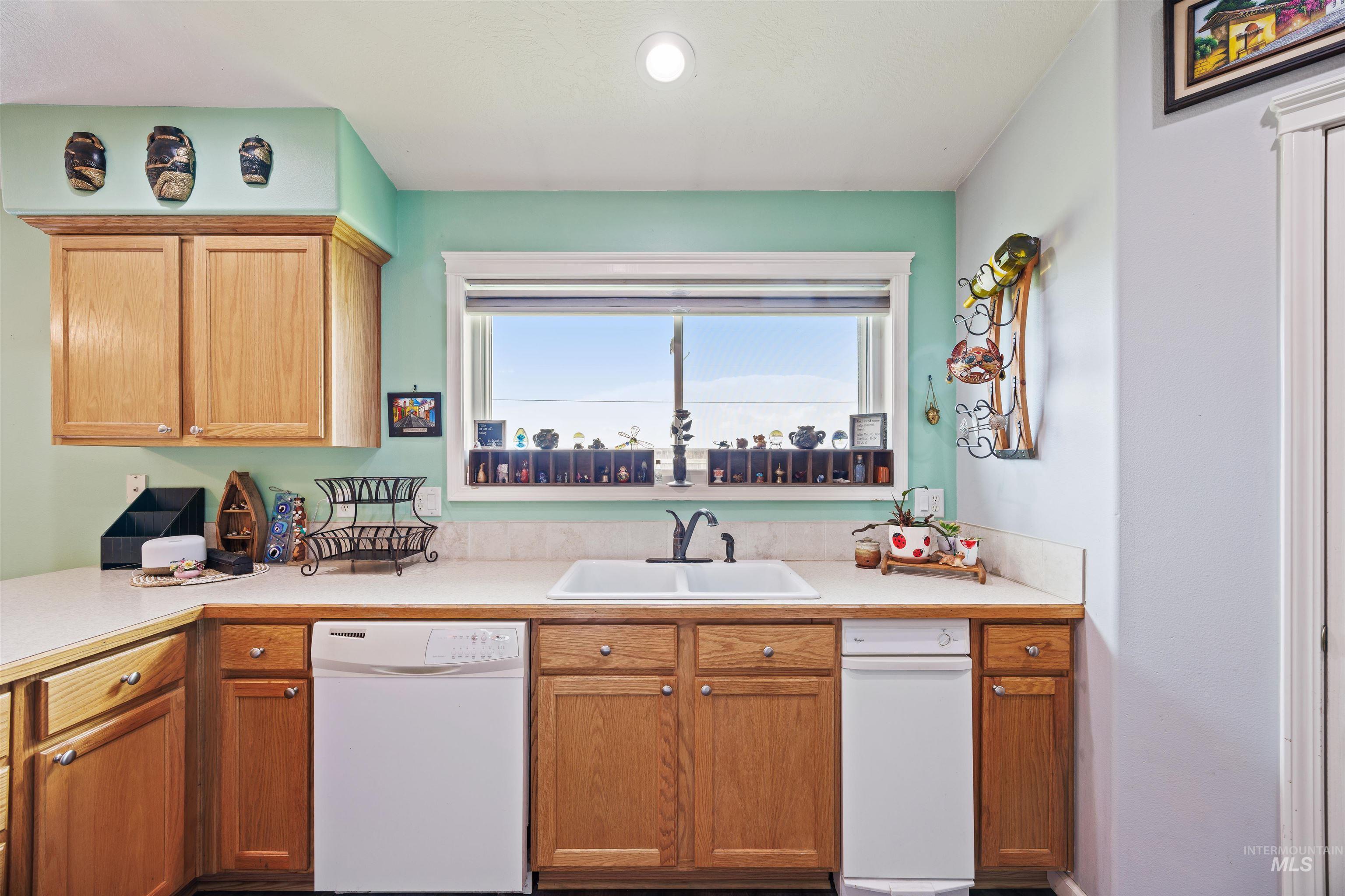 Kitchen with white dishwasher and light countertops