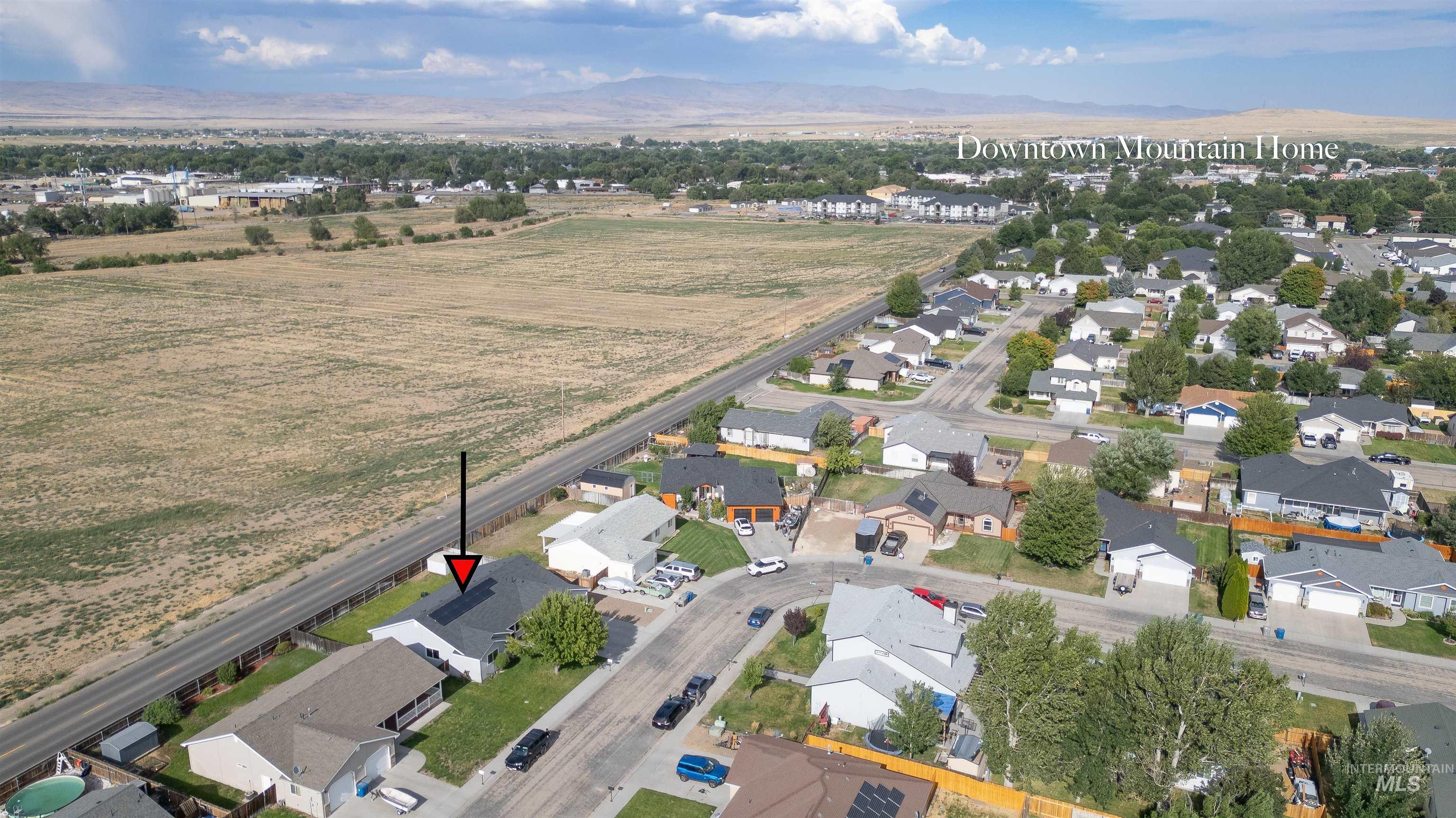 Aerial view of property's location with nearby suburban area