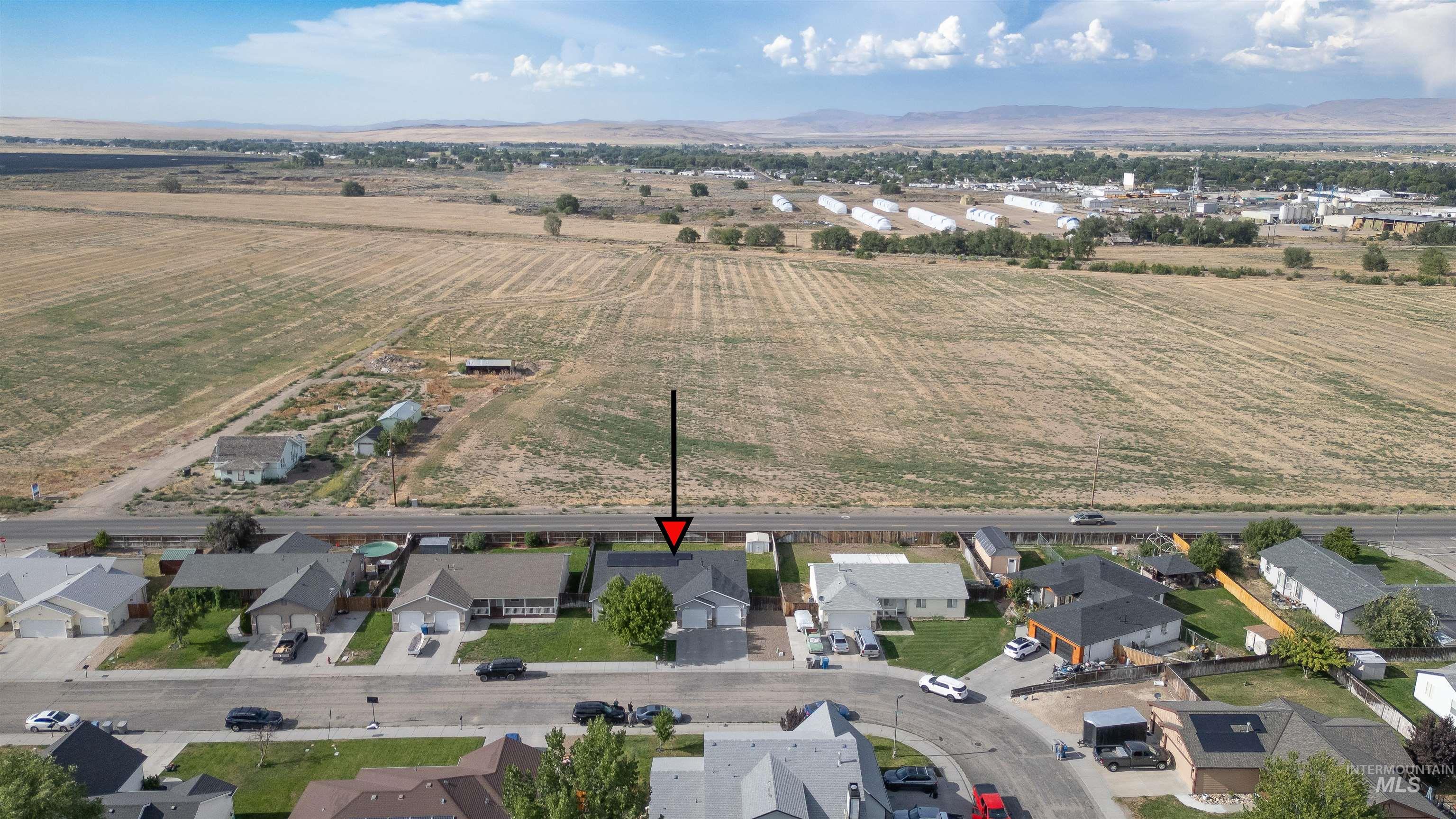 View of rural area featuring mountains and nearby suburban area