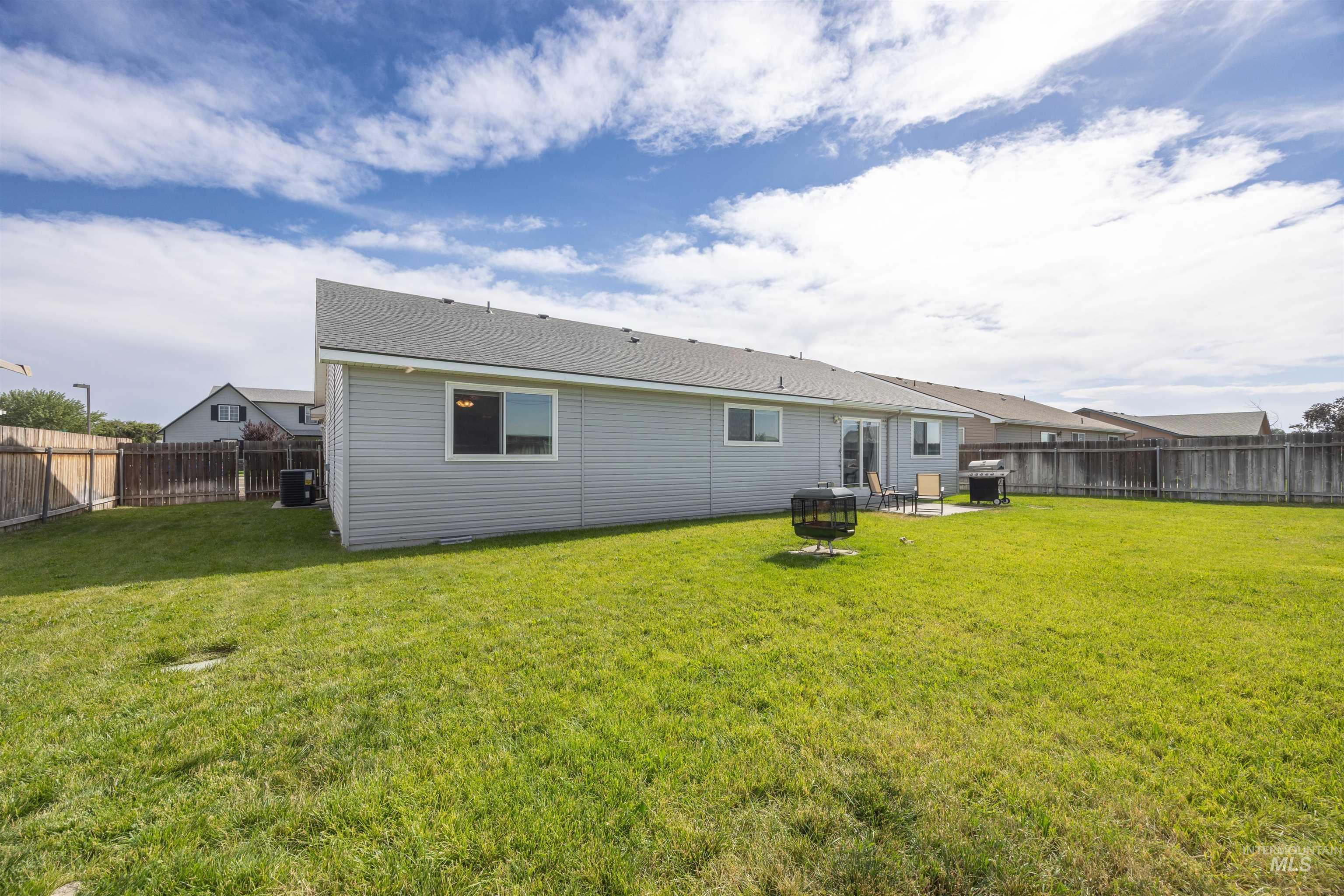 Rear view of house with a fenced backyard