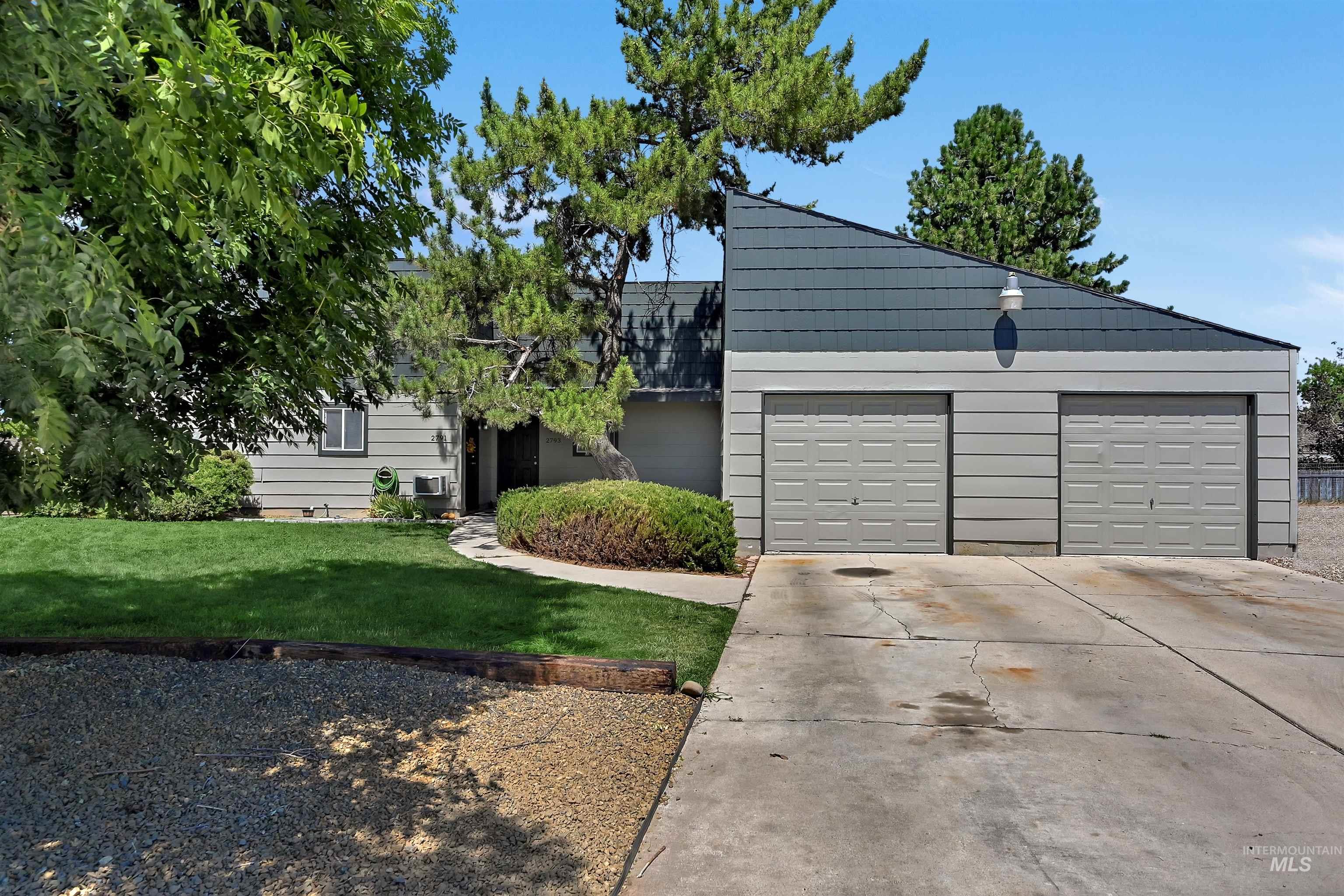 View of front facade with concrete driveway, a garage, and a front yard