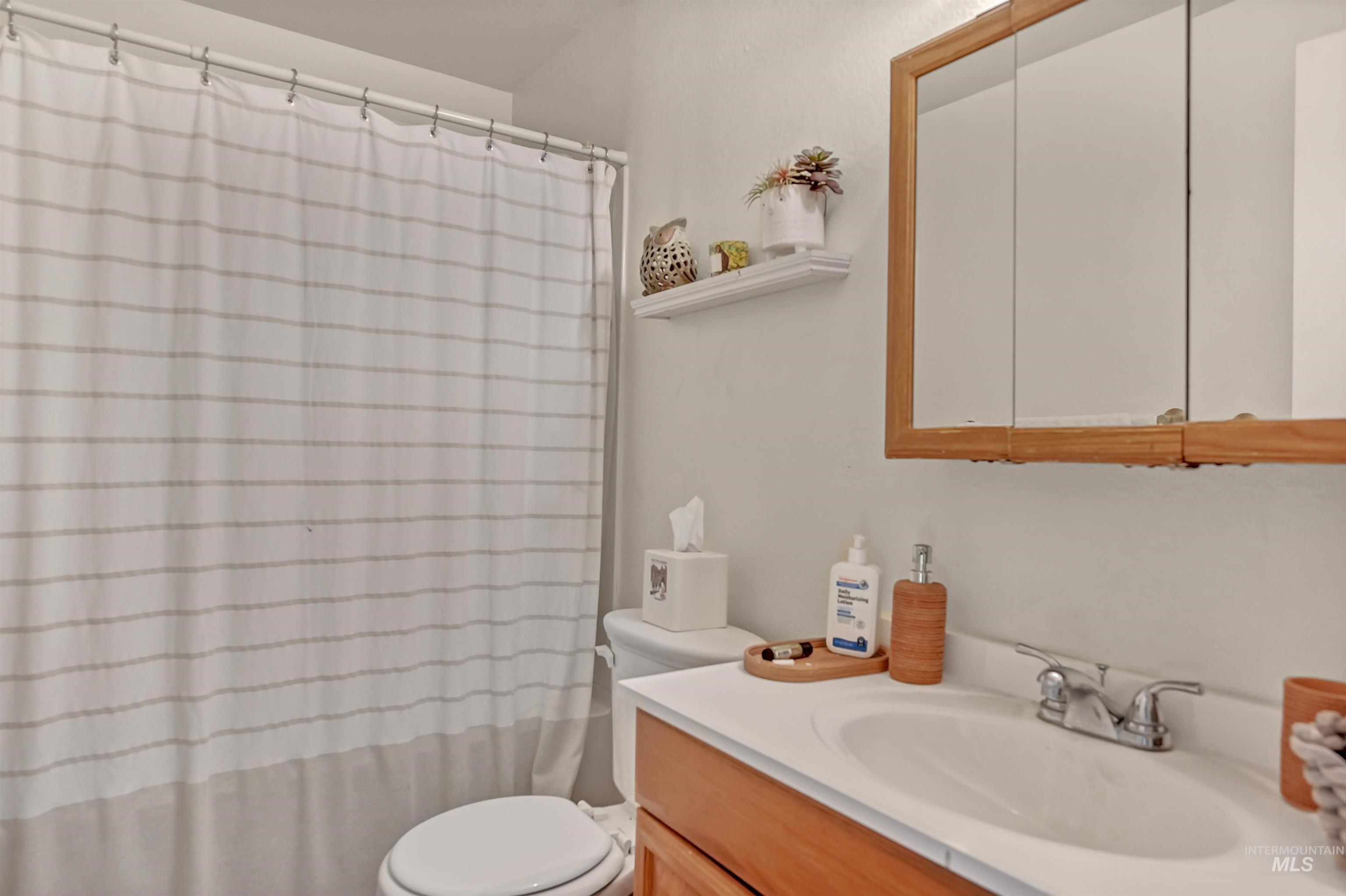 Full bath featuring vanity and a shower with shower curtain