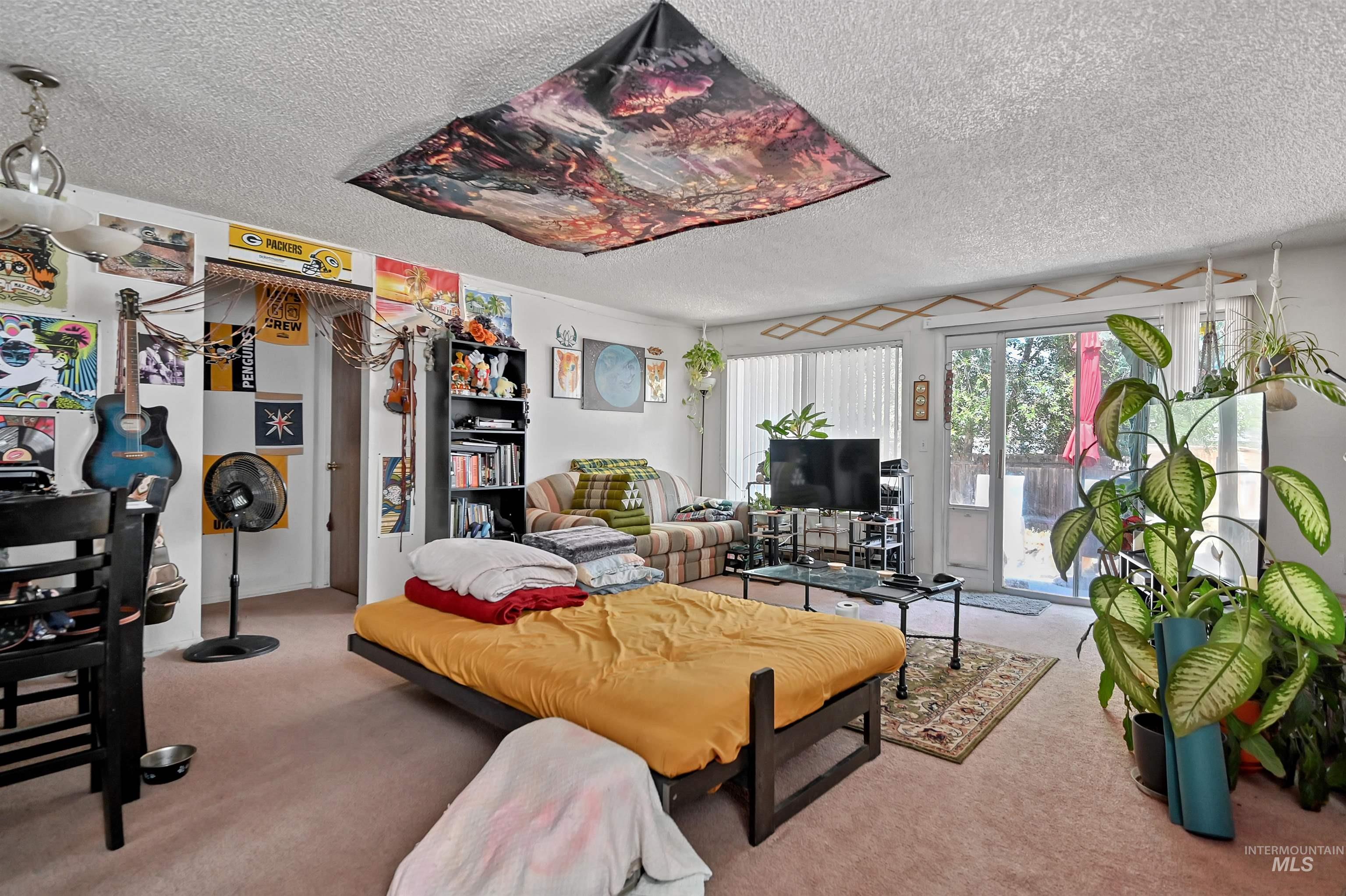 Living room featuring carpet flooring and a textured ceiling