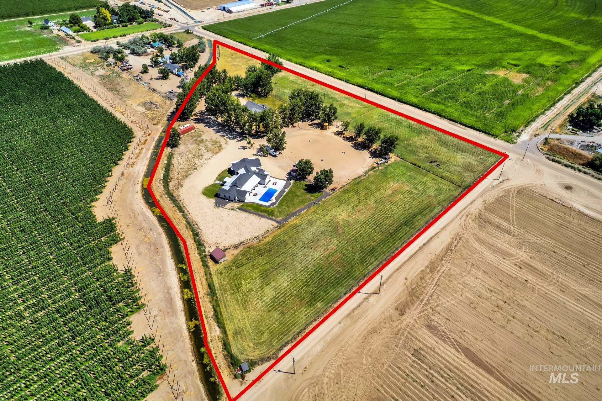 Aerial view of sparsely populated area featuring property parcel outlined and abundant farmland