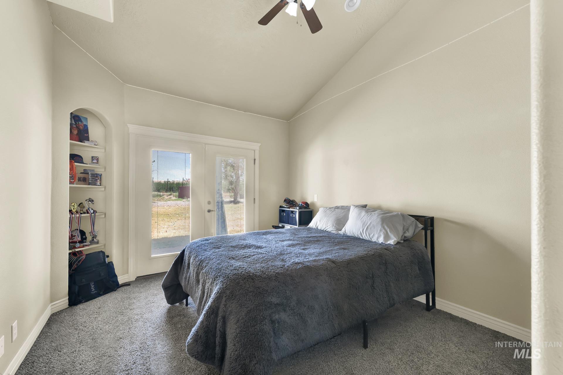 Bedroom with access to outside, vaulted ceiling, carpet, french doors, and ceiling fan